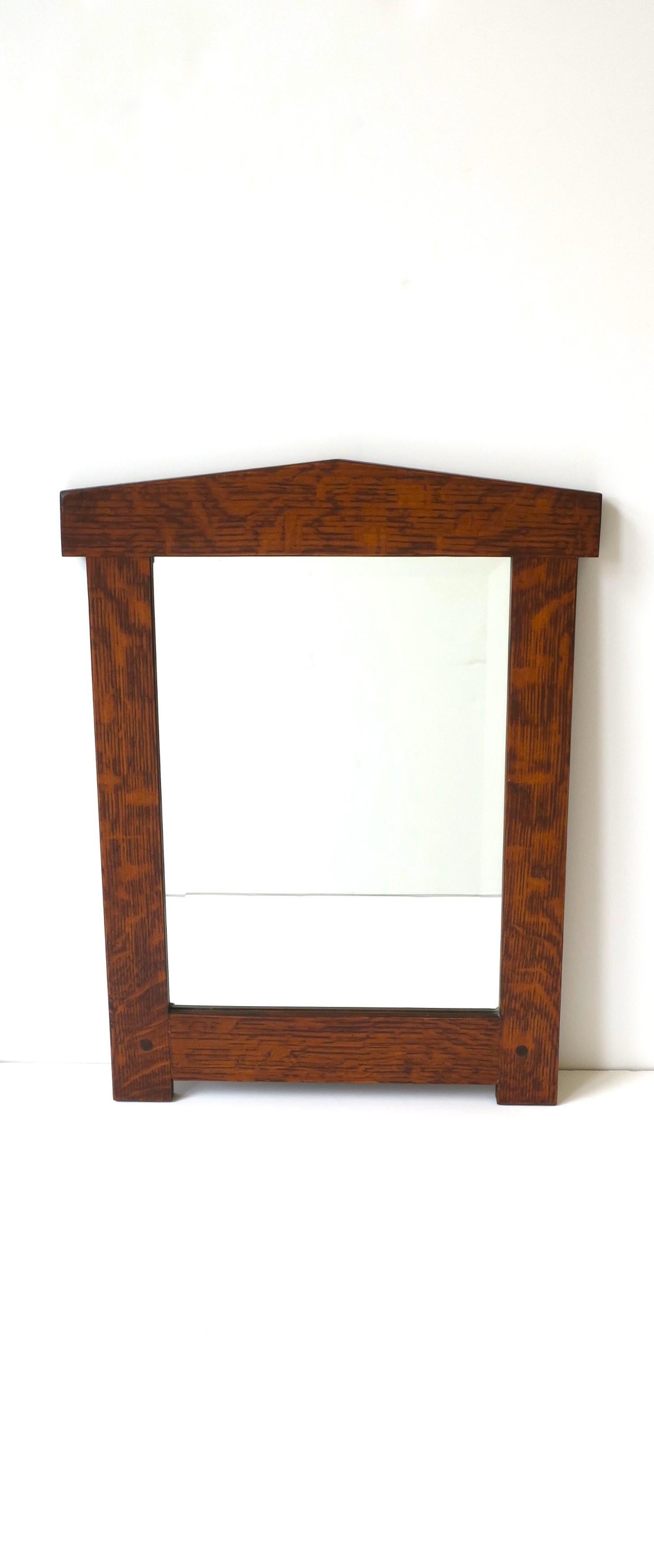A wood framed wall mirror with beveled mirrored glass, Empire Revival style, circa 20th century, Europe. This mirror is rectangular with a beautiful wood frame and beveled mirrored glass. A great wall mirror for a hall, foyer, closet, vanity area,