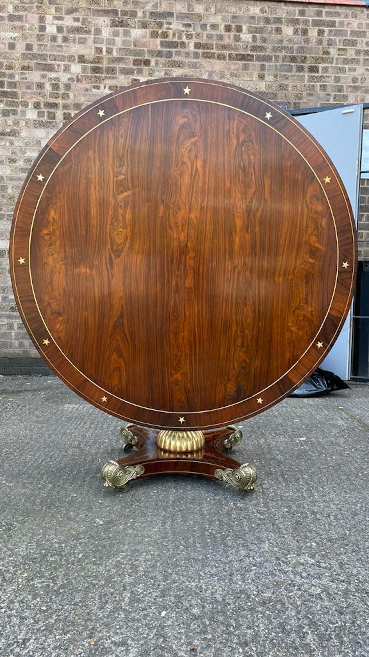French Empire rosewood & brass-inlaid dining table, 19th century.
Early 19th century rosewood breakfast / center / dining table. This is simply the finest in craftsmanship. The gilt gold reverse claw feet on a boule inlaid base with gilt column