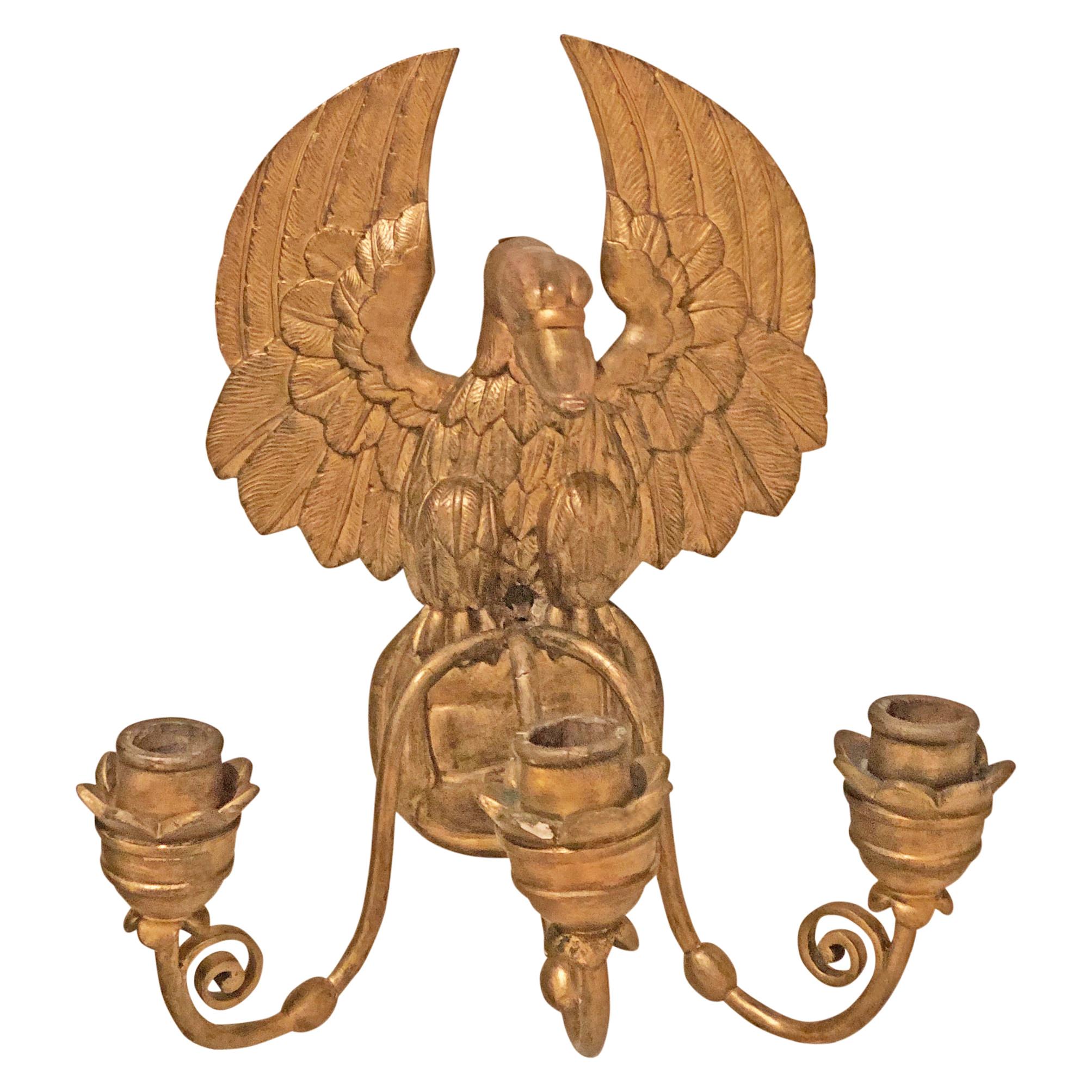 Pair of Empire sconces with three sockets each. The back is shaped like an eagle, made out of fire gilt, carved wood.