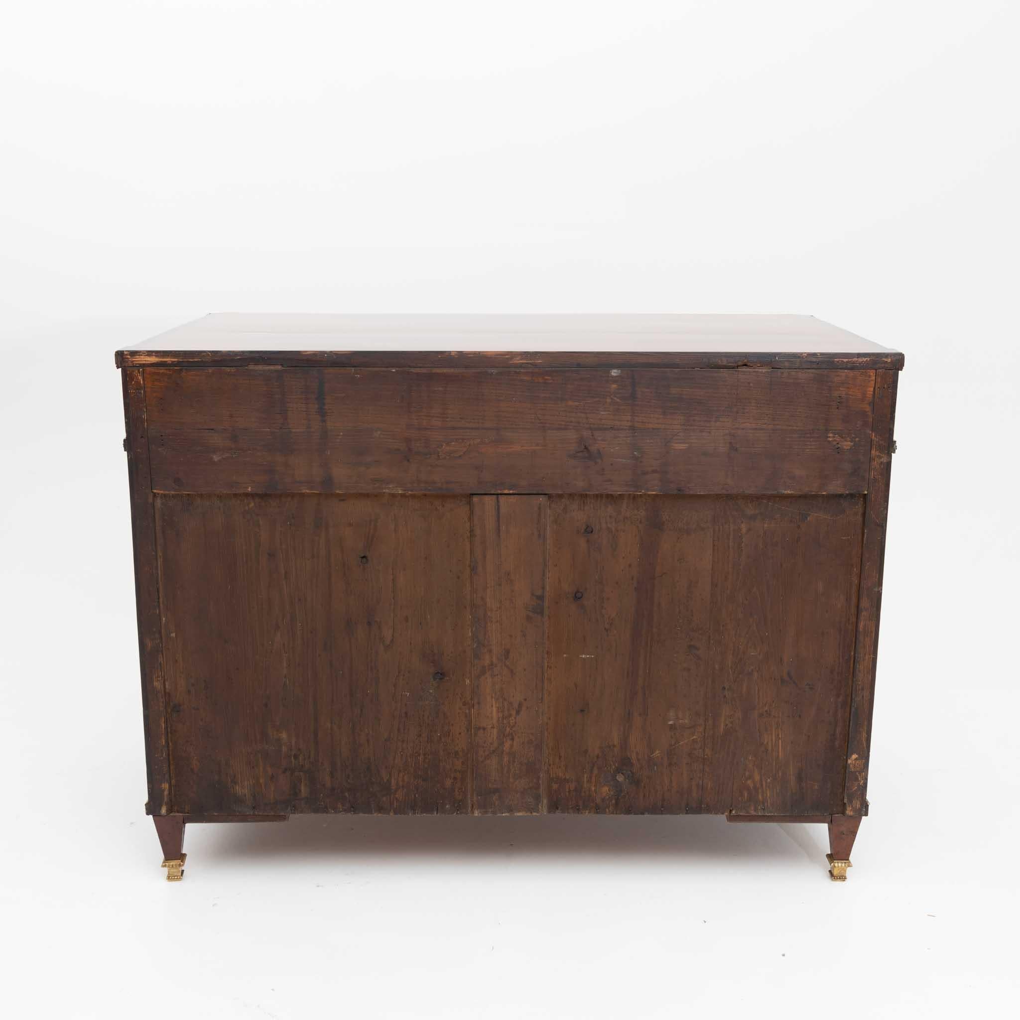 Two-door sideboard on square-pointed feet with brass sabots, brass moldings and inlaid upper drawer with leaf motifs and diamond décor. The sideboard was restored and hand polished. Mahogany veneered. 