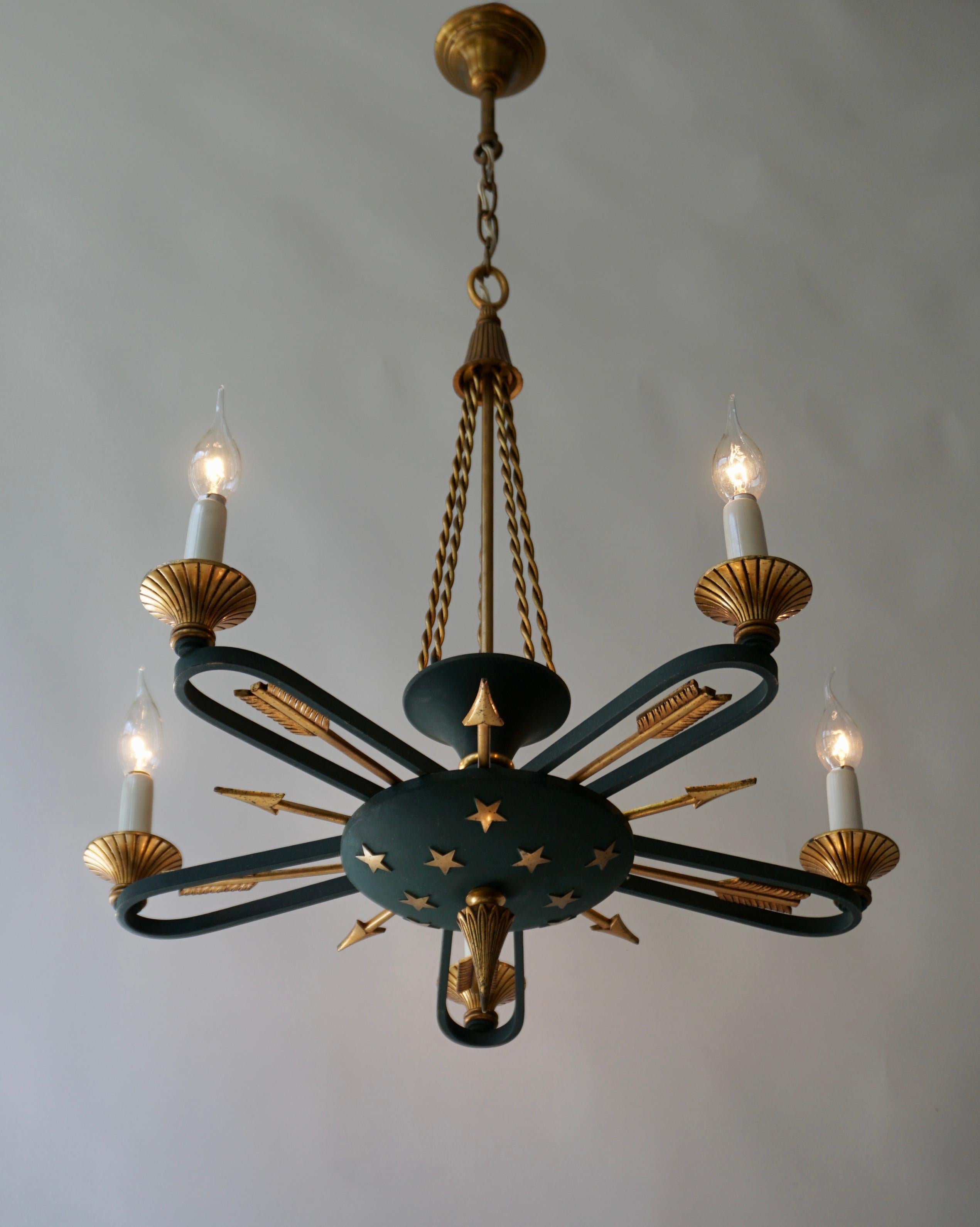 Empire Style gilt brass chandelier with stars and  arrows details.

Beautiful golden arrows and stars chandelier in gilded brass and antique green. Good general condition considering the period of the mid-20th century.

The chandelier has six