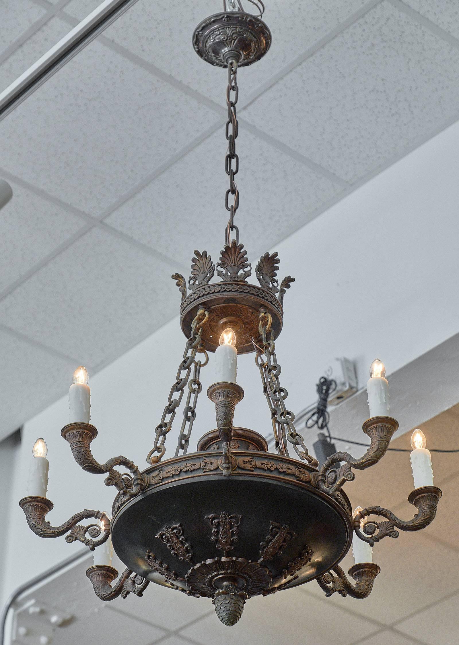 Antique Empire style bronze chandelier from France with eight cornucopia branches, acanthus leaves and stylized floral decor throughout. It has been professionally wired to fit US standards.