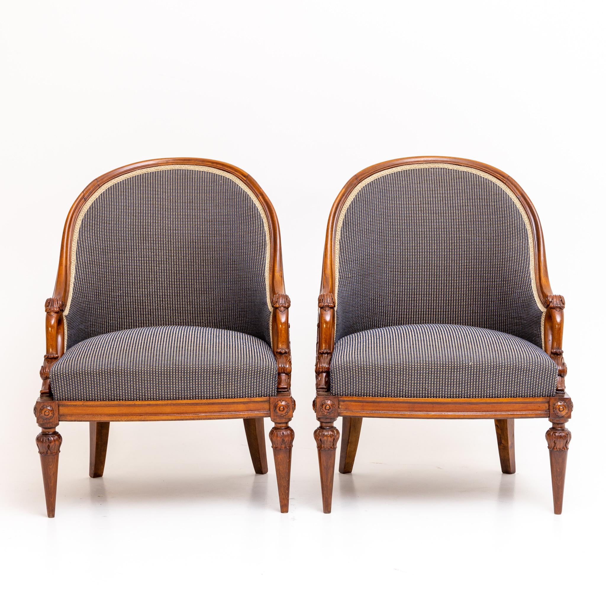 Pair of Empire style bergeren with carved swan necks as armrests and high rounded backs. The bergeren are newly upholstered and covered.