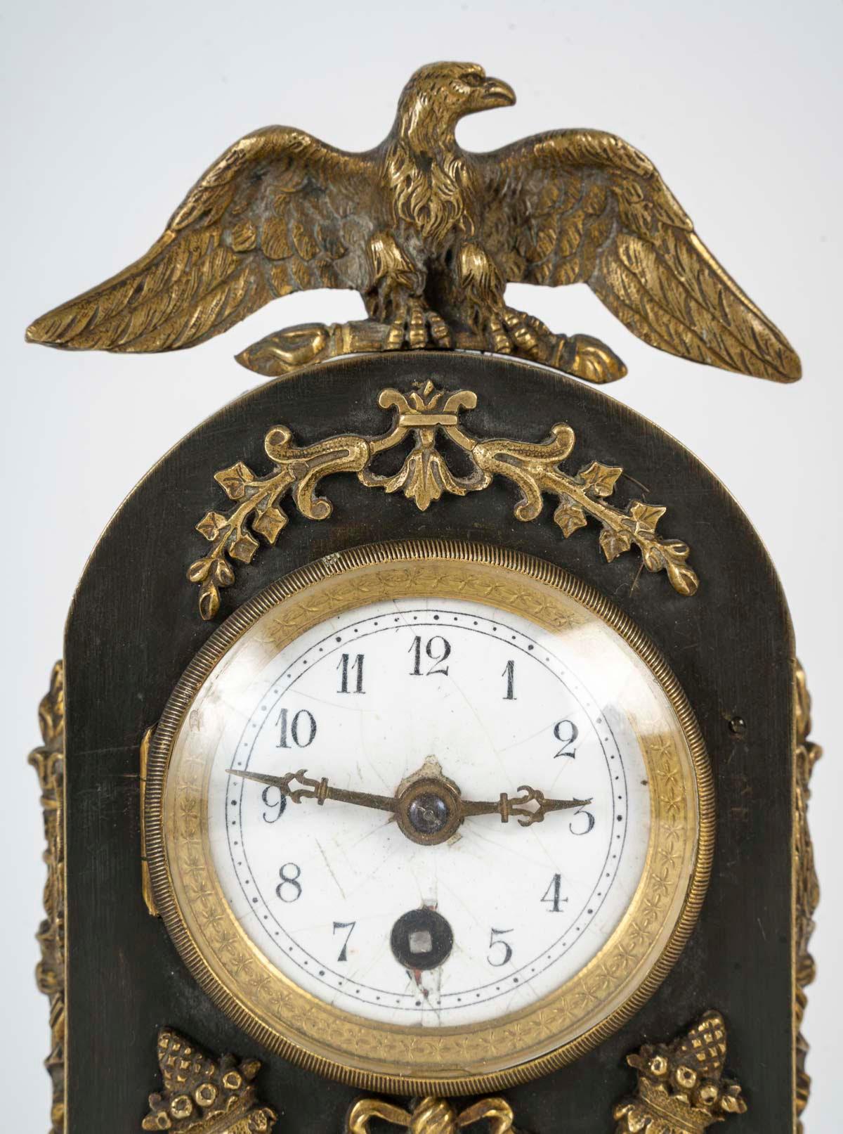 Empire style bronze travel clock, late 19th century or early 20th century.

Empire style bronze travel clock with double patina, late 19th or early 20th century, (movement to be revised).
H: 22cm, W: 12cm, D: 8cm