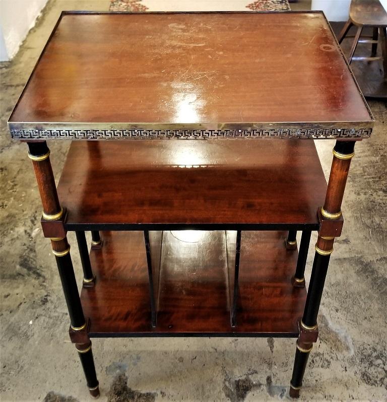 Presenting a beautiful Empire style Canterbury side table.

Made of flame mahogany, ebony and gilt and brass banding.

The table has a frieze gallaried top edged in Grecian themed pierced brass molding.

It has four supporting columns on each