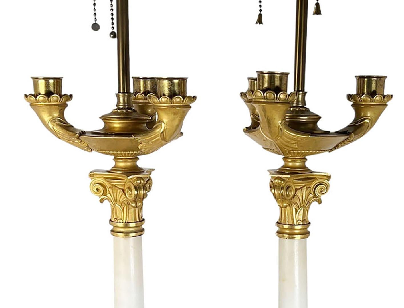 A pair of empire style candelabra with white Carrera marble and bronze dore mounts. Circa 1900, France. 
