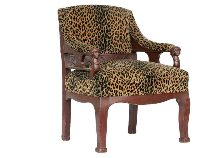 Vintage pair of hand carved Empire style chair with leopard print seat tops featuring two carved female busts on each arm.