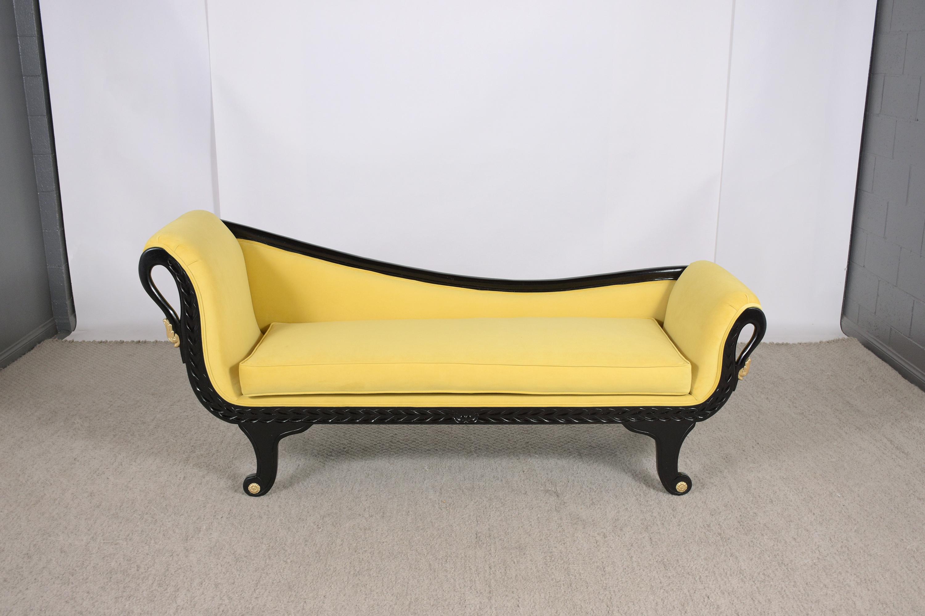 An elegant late vintage chaise lounge beautifully crafted out of mahogany wood professionally restored by our craftsmen team in-house. This fabulous piece features a beautiful ebonized finish, carved scrolled legs & armrests design with gilt and
