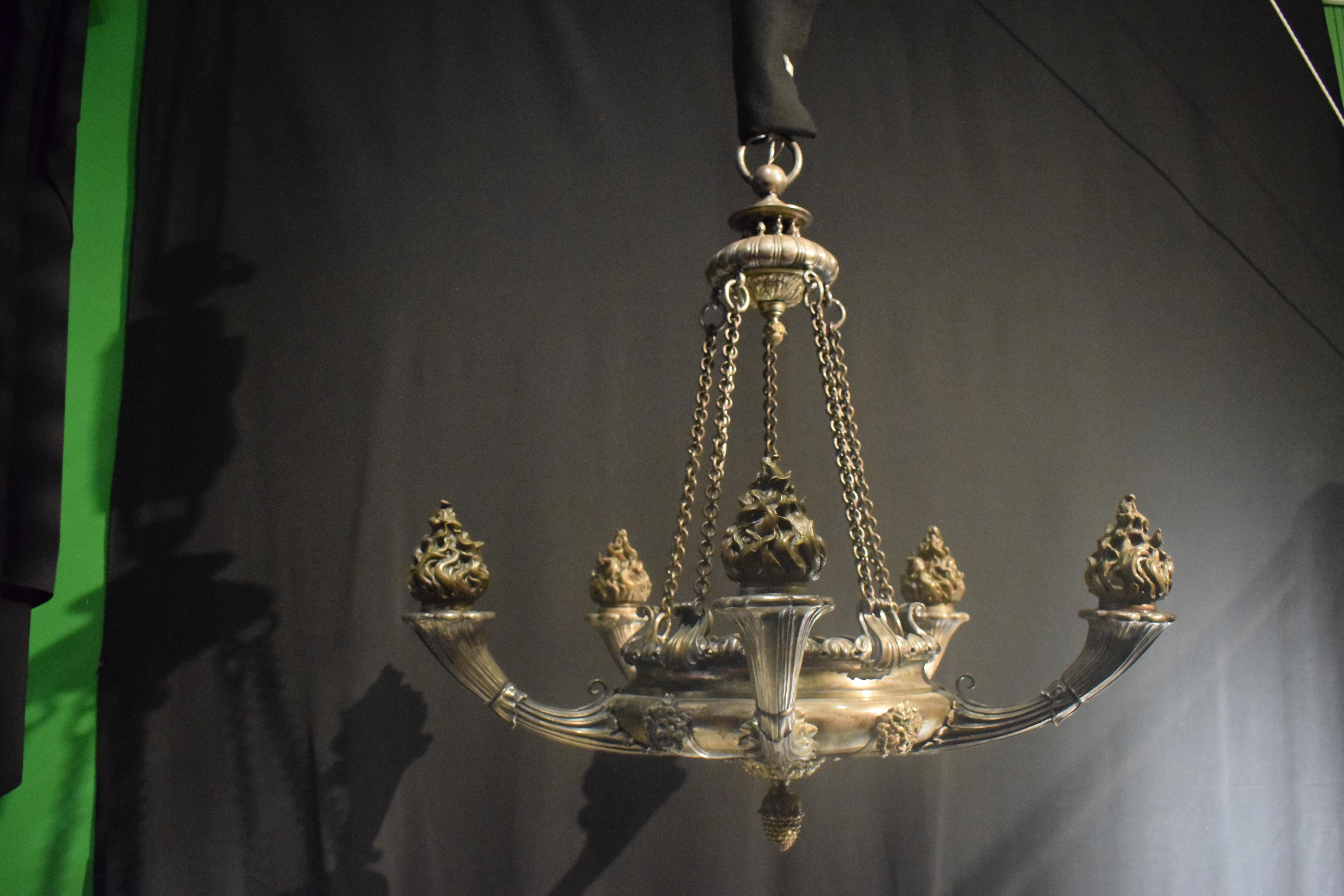 A High Quality and Very Fine Silver over Bronze Empire style Chandelier featuring Pompeian Masks. Great Quality. France, circa 1910. 5 interior lights. 
Dimensions: Height 45