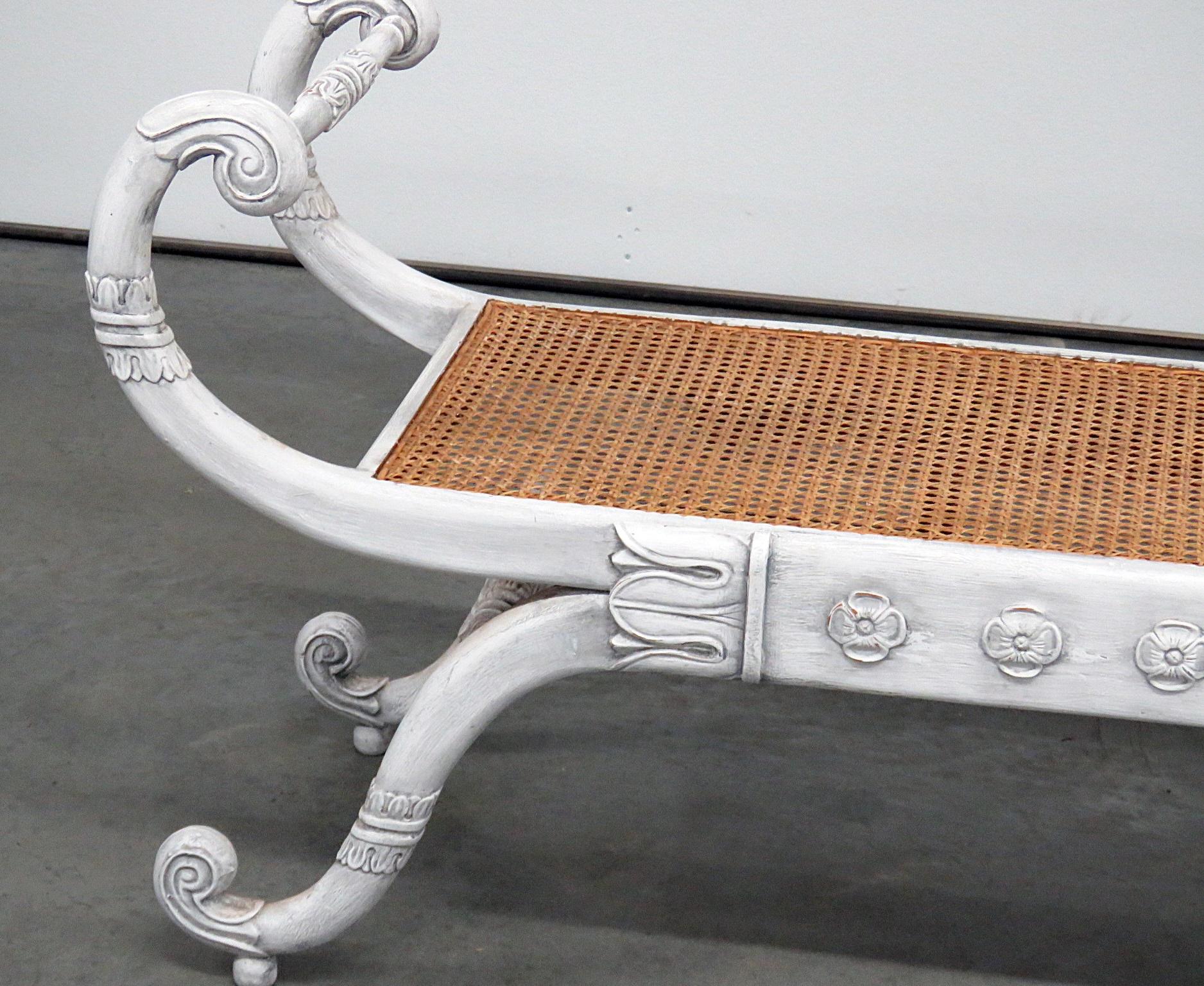 Empire style distressed painted window bench with a cane seat.