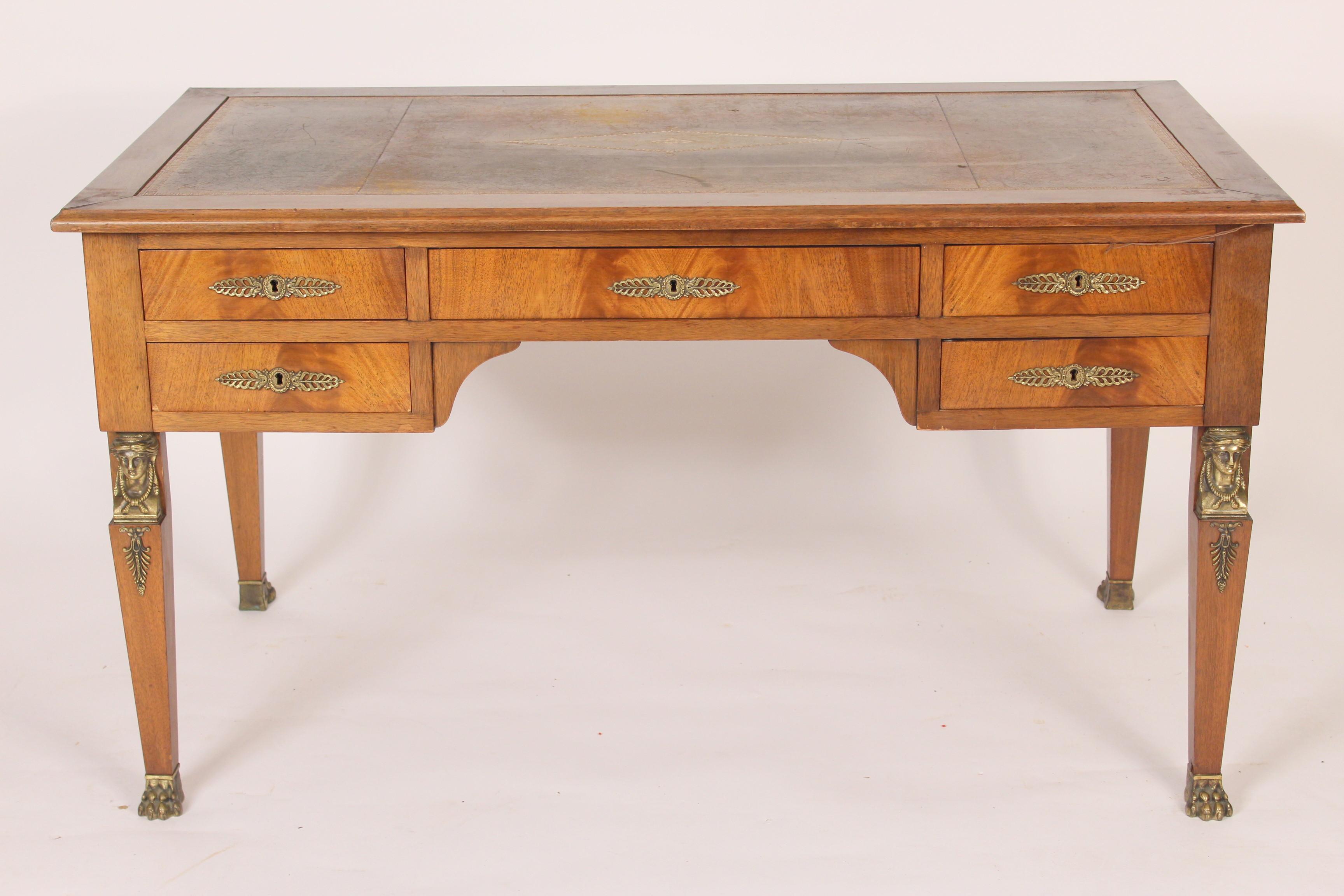 Empire style mahogany desk with a tooled leather top and brass mounts, made circa 1950s.