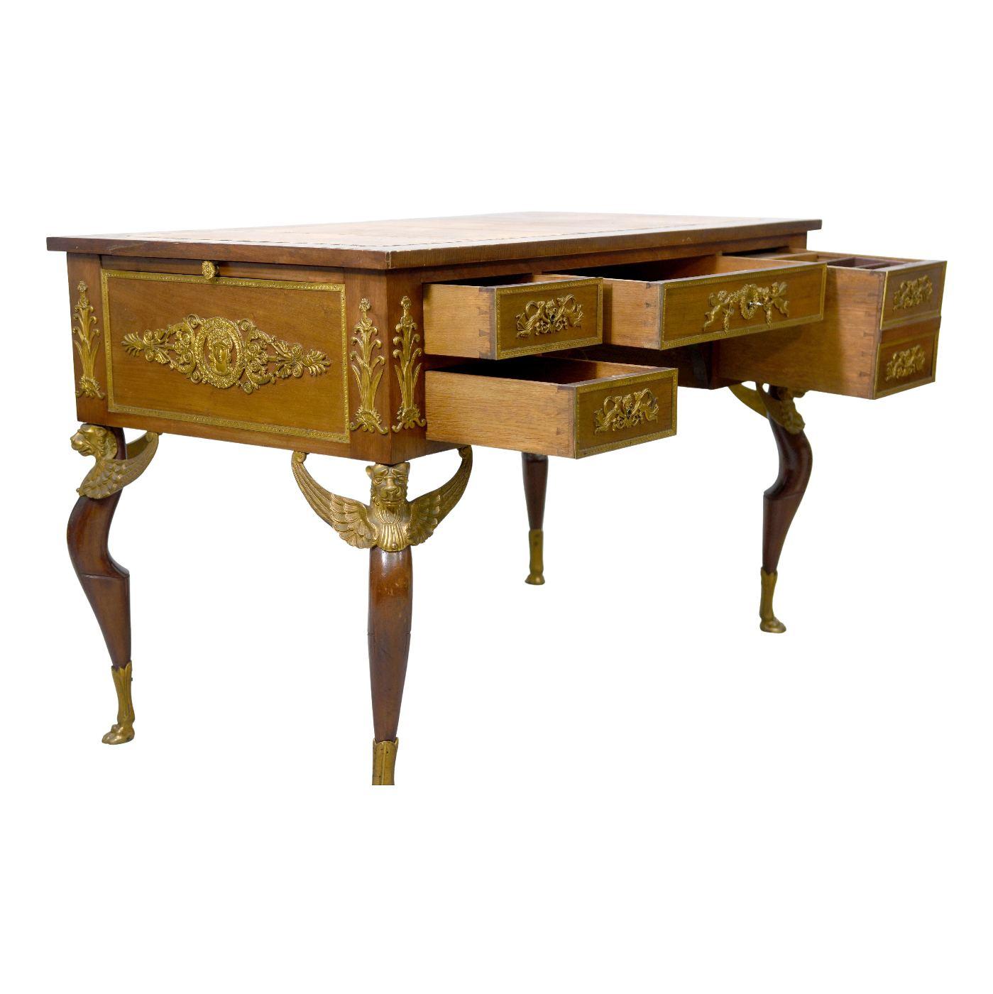 Lady's desk with Empire style mahogany, base decorated with griffins, very beautiful register of gilded bronzes oak drawer bottoms, top and zippers trimmed with brown and green Moroccan, the leather of the desk would eventually have to change.