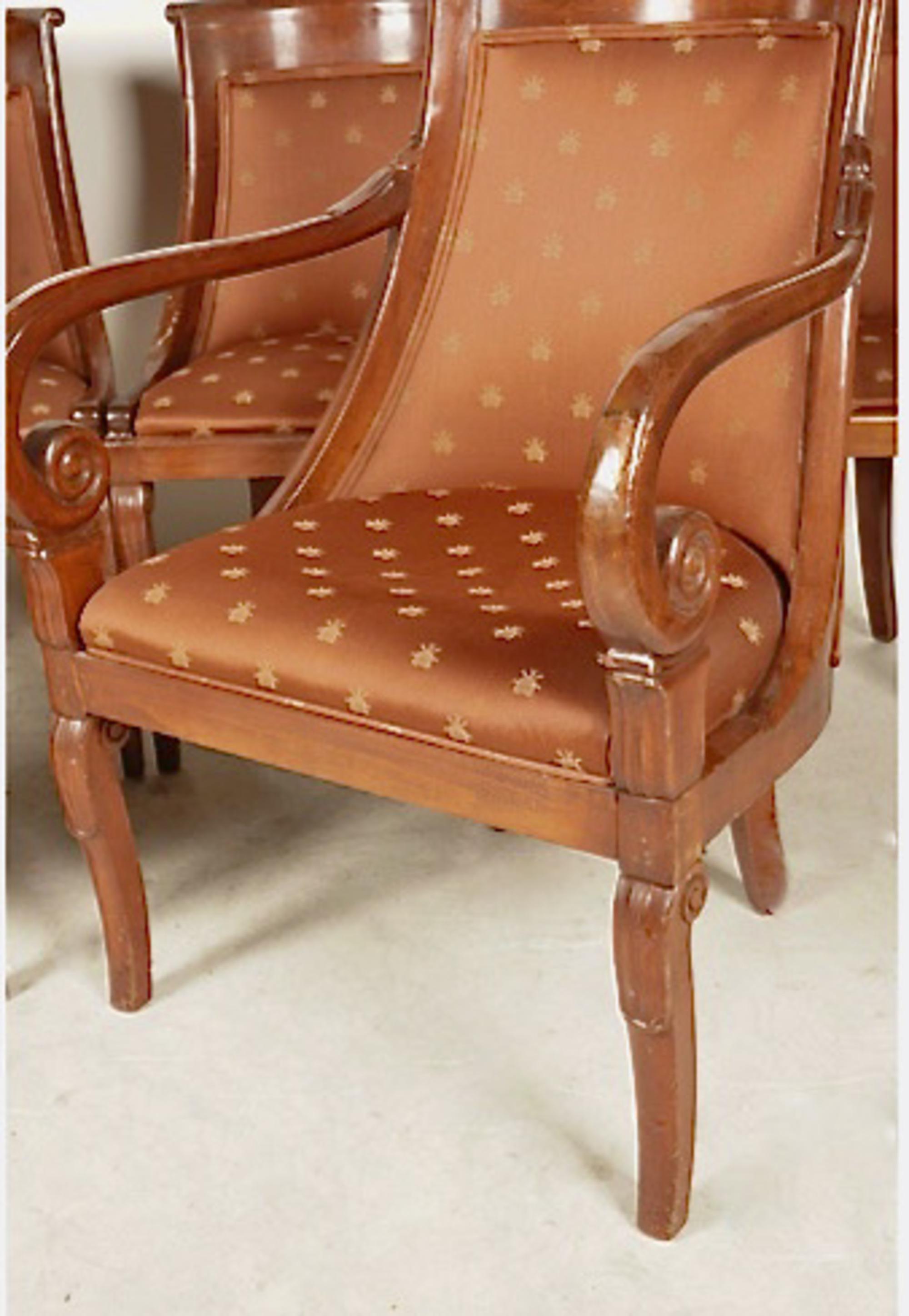This is a charming set of six carved and inlaid mahogany dining chairs in the French Empire style. The chairs date to the second half of the 20th century and are in very good condition. Chairs in the Empire-style with scooped back and carved curved