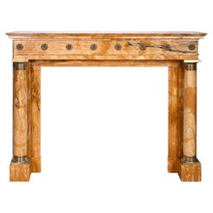 Empire style fireplace in Sienna yellow marble with columns and gilt bronze rose