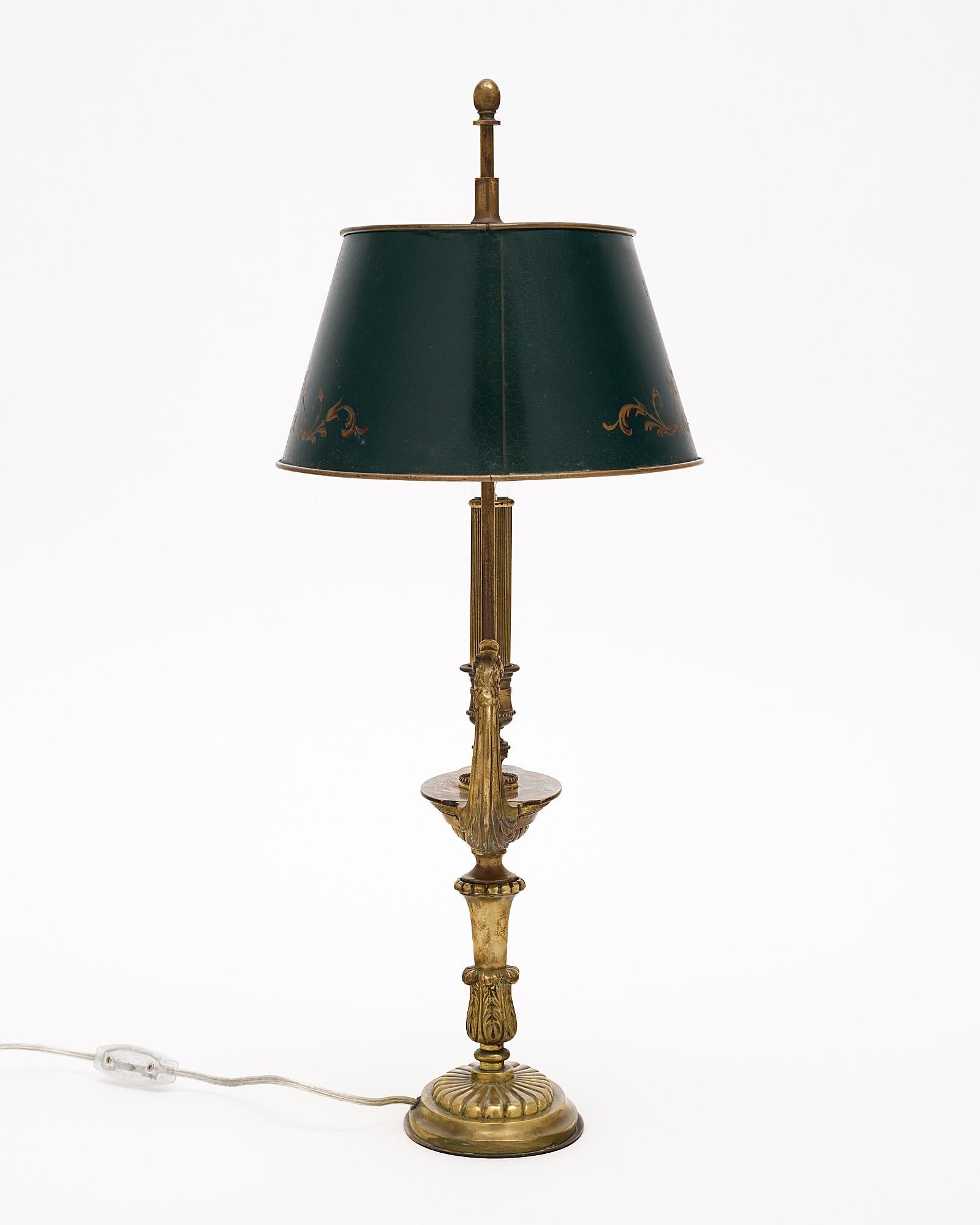 Lamp, French, “Bouillote”, made of finely cast bronze. The piece mimics a traditional oil lamp and is topped with a gold leaf painted adjustable lamp shade. It has been newly wired to fit US standards. The measurements listed include the shade.