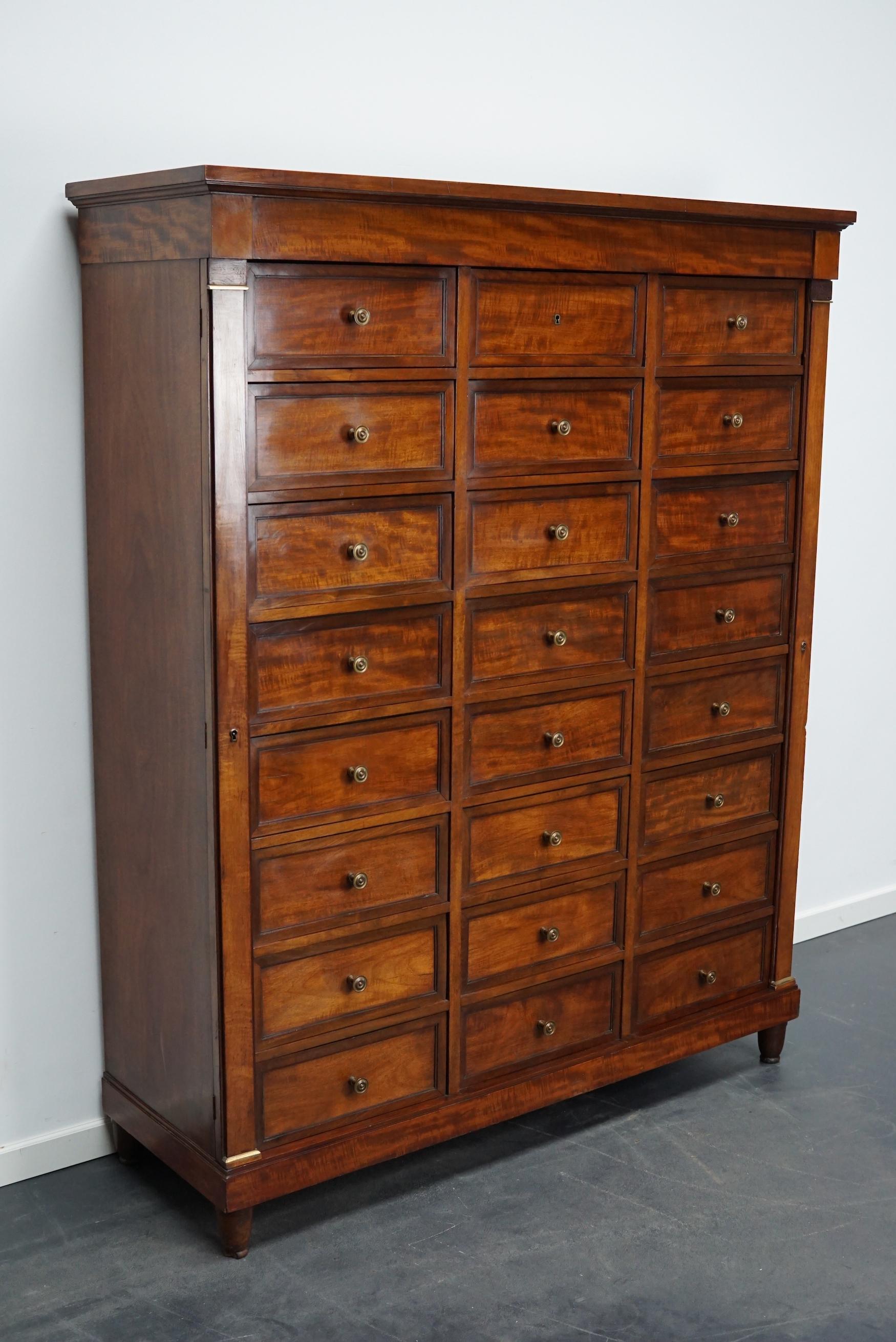 This filing cabinet was made around the 1920/30s in France. It is made from mahogany and oak with drop down doors in the front of the drawers. It was used in 