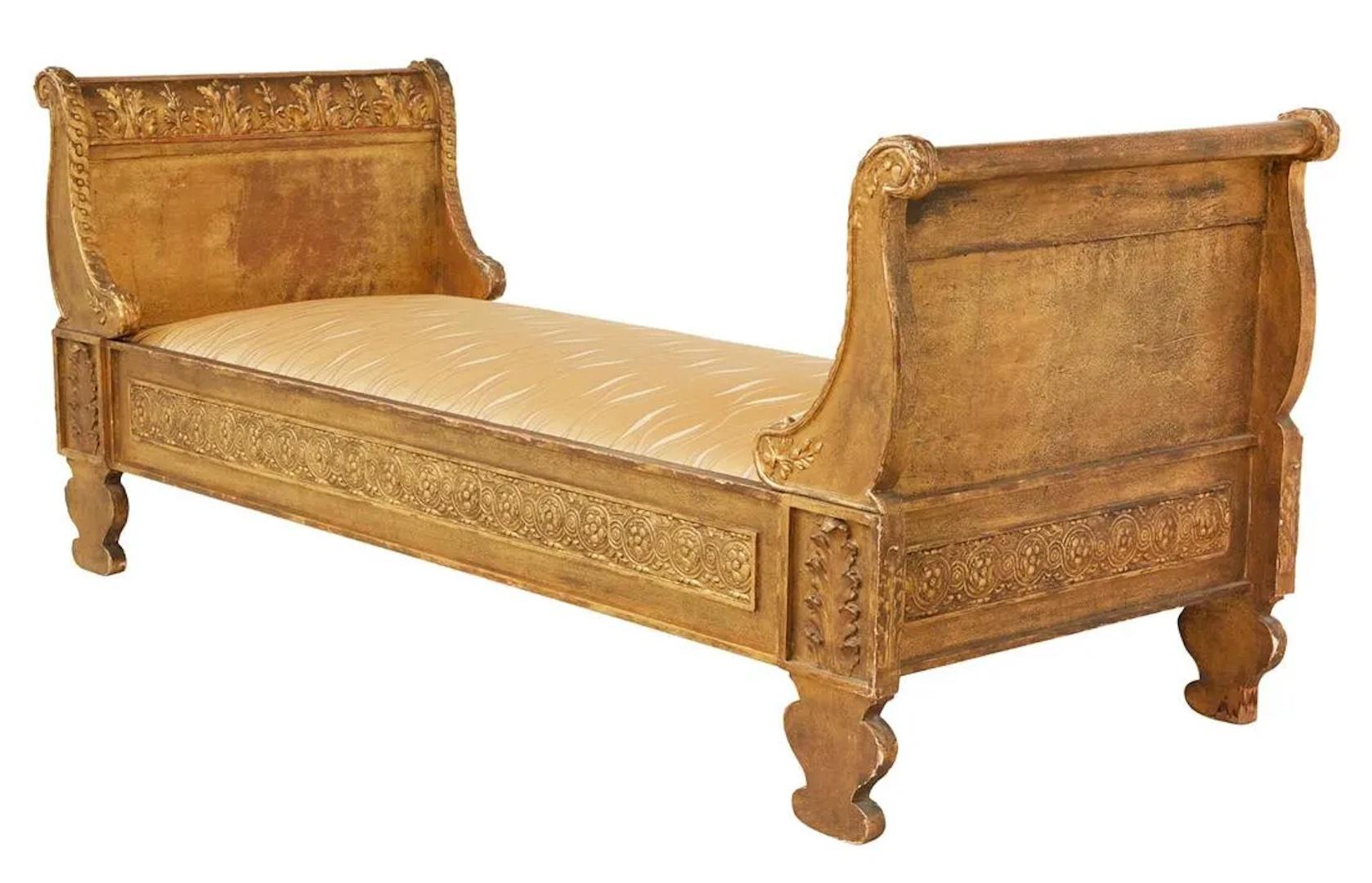 Heavily carved on all sides, the details beckon you to admire this Empire gilt daybed. Perfect for open seating between two rooms yet generous size for relaxing.
**Needs to be reupholstered; daybed comes with gold fabric on mattress, see pictures.