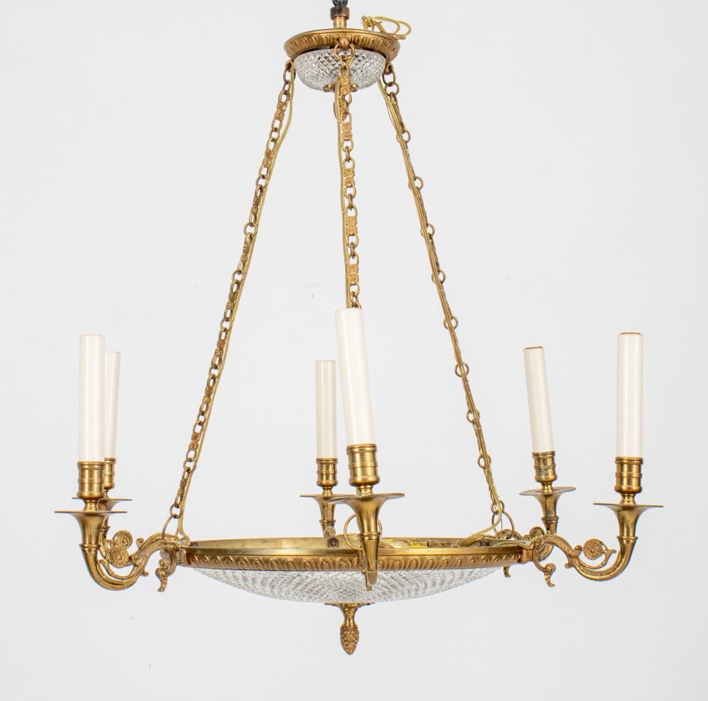 Empire style chandelier with cut glass plate and canopy within a gilt metal support and three chains supporting 6 lights. 

Dimensions: 27