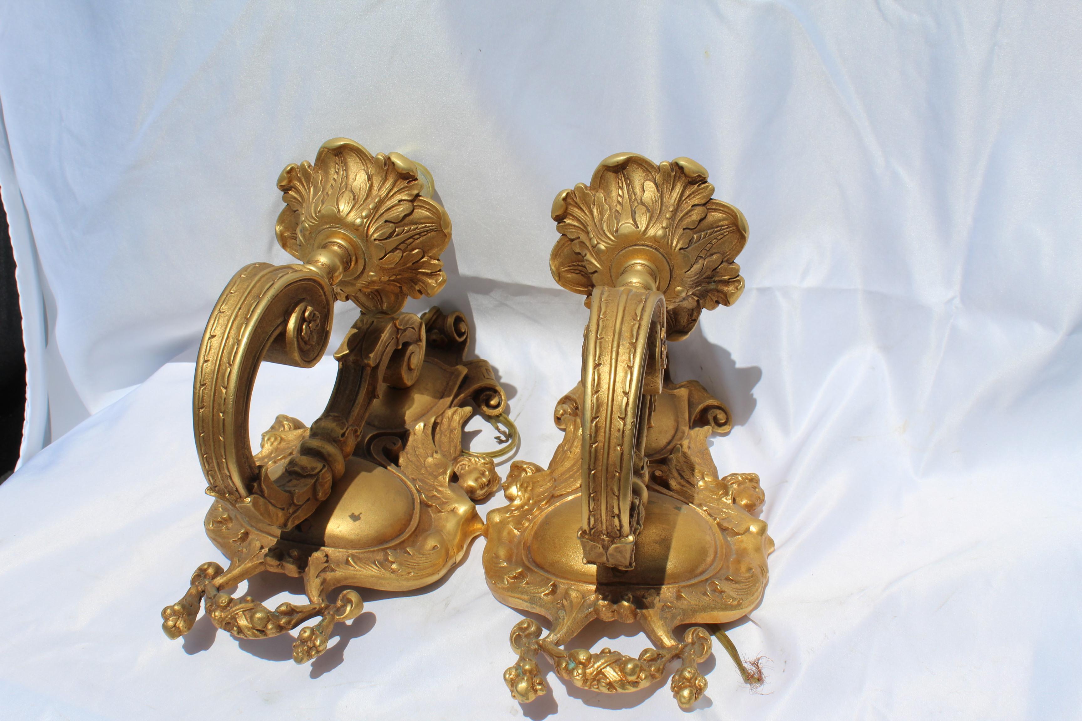 Late 20th century 18-karat doré' gold sconces. Has female angles on left and right sides. Made from the originals. Good size and wired. No shades, but could have had the flame shades. Looking good on the wall. Packing and shipping can be quoted at