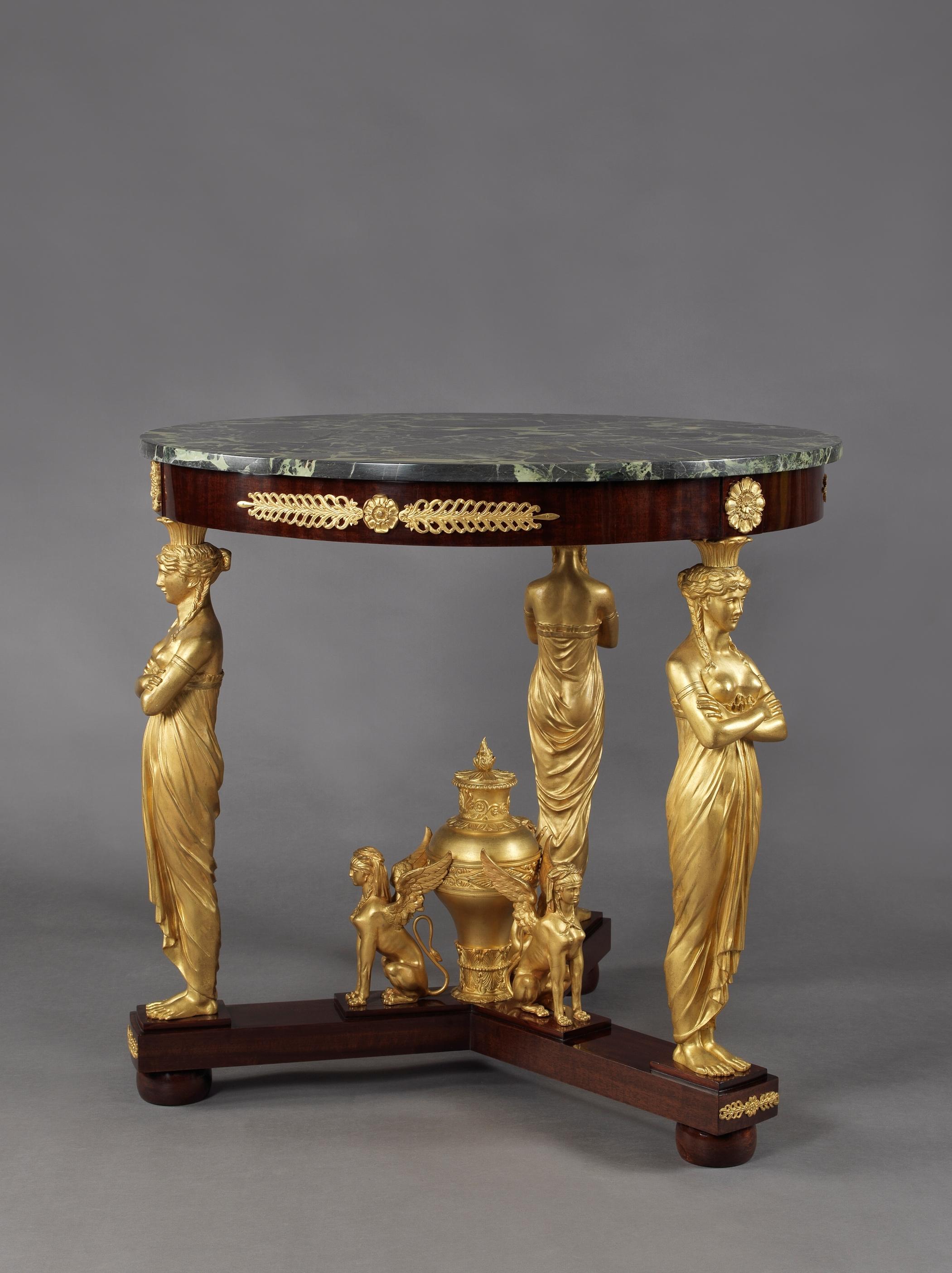 A fine Empire style gilt-bronze and mahogany gueridon, with a Verde antico marble top, in the manner of Jacob-Desmalter. 

French, circa 1880. 

The circular Verde antico marble top above a mahogany frieze with rosettes and palmette mounts