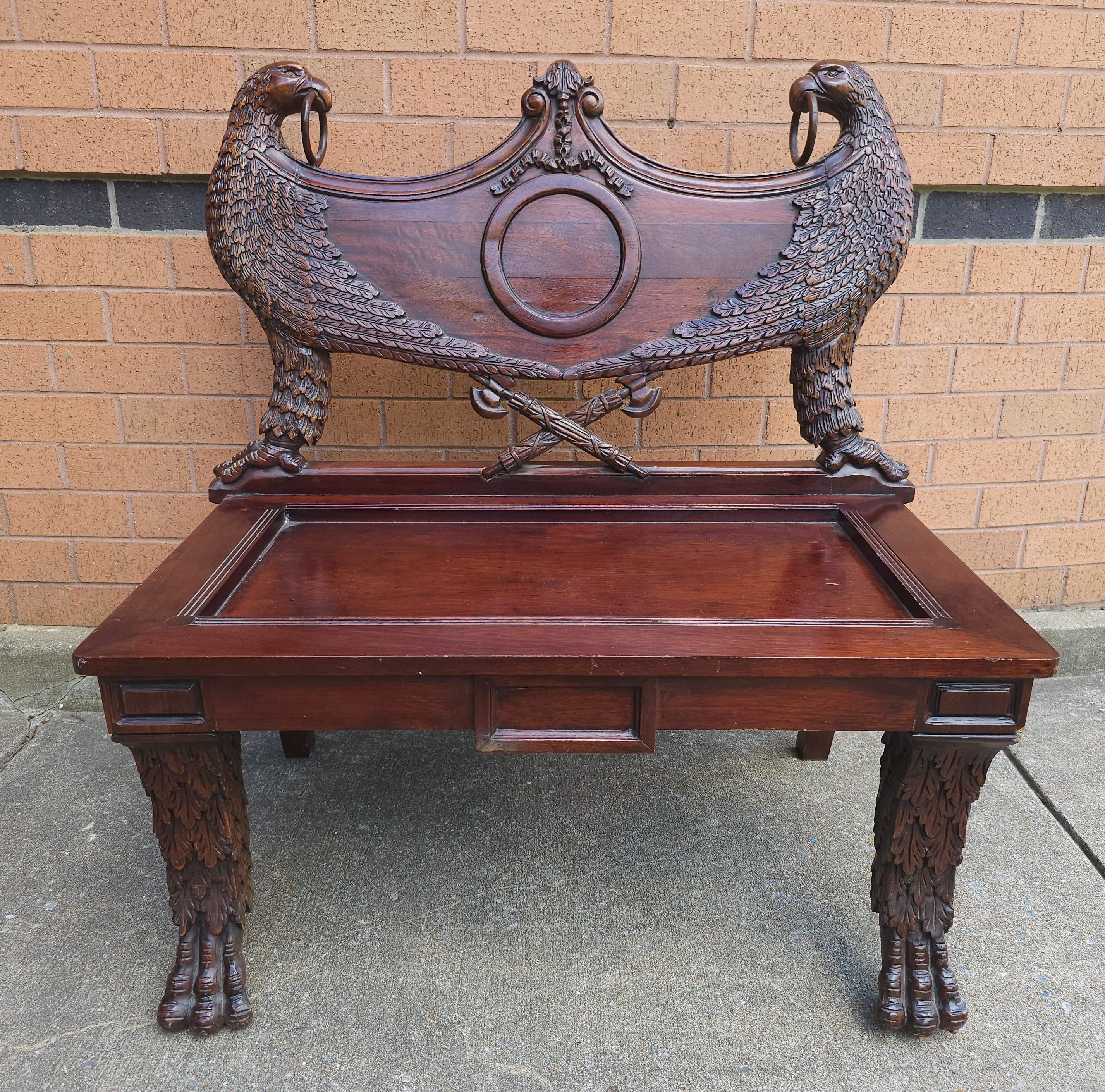 An early 20th Century Empire Style Heraldic coat of arms Intricately Carved Mahogany Double Eagle Bench with loose seat cushion. Measures 36.5