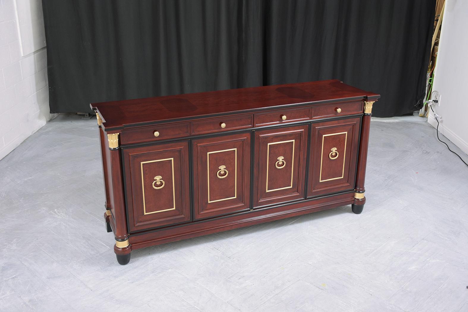 An extraordinary 1970s empire-style buffet in excellent condition is hand-crafted out of mahogany and is completely restored by our expert professional craftsmen team. This sideboard is eye-catching and features elegant mahogany color accentuated