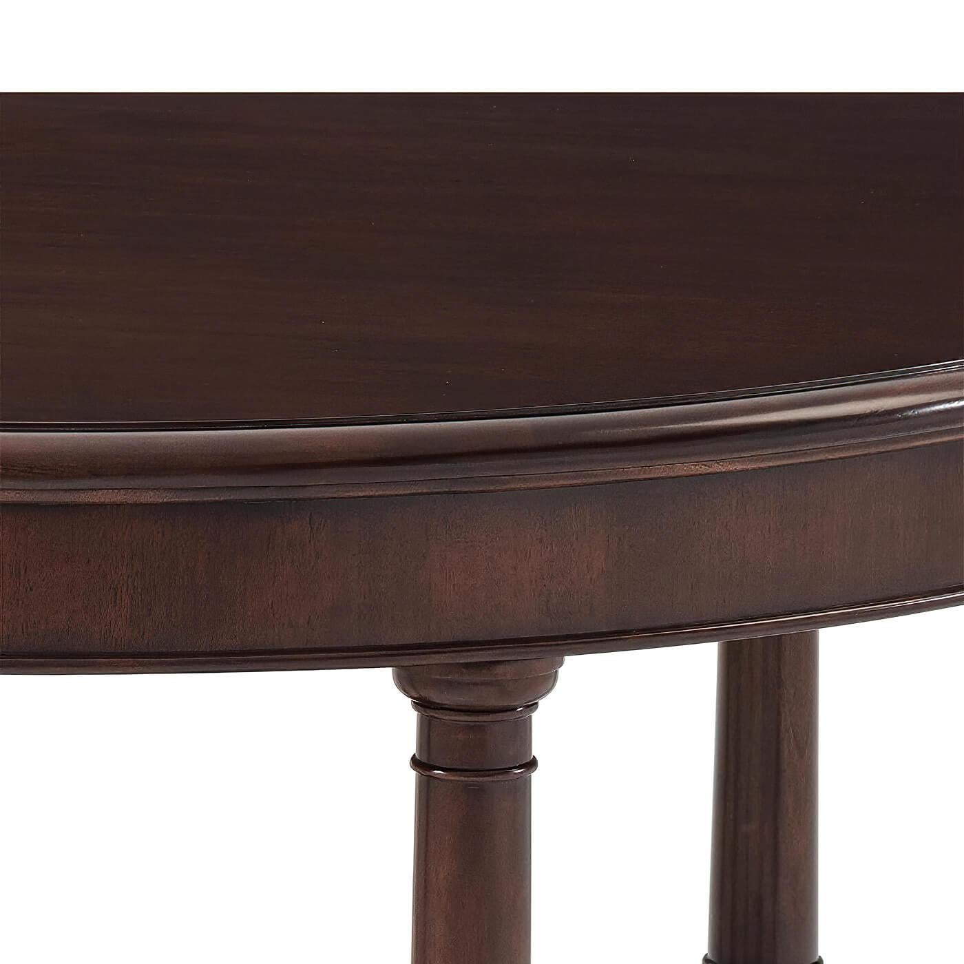 A French Empire style mahogany center table with six turned column-form legs with reeded baluster carvings all raised on a six-point star shaped plinth base set on molded edge feet. 
Dimensions: 52