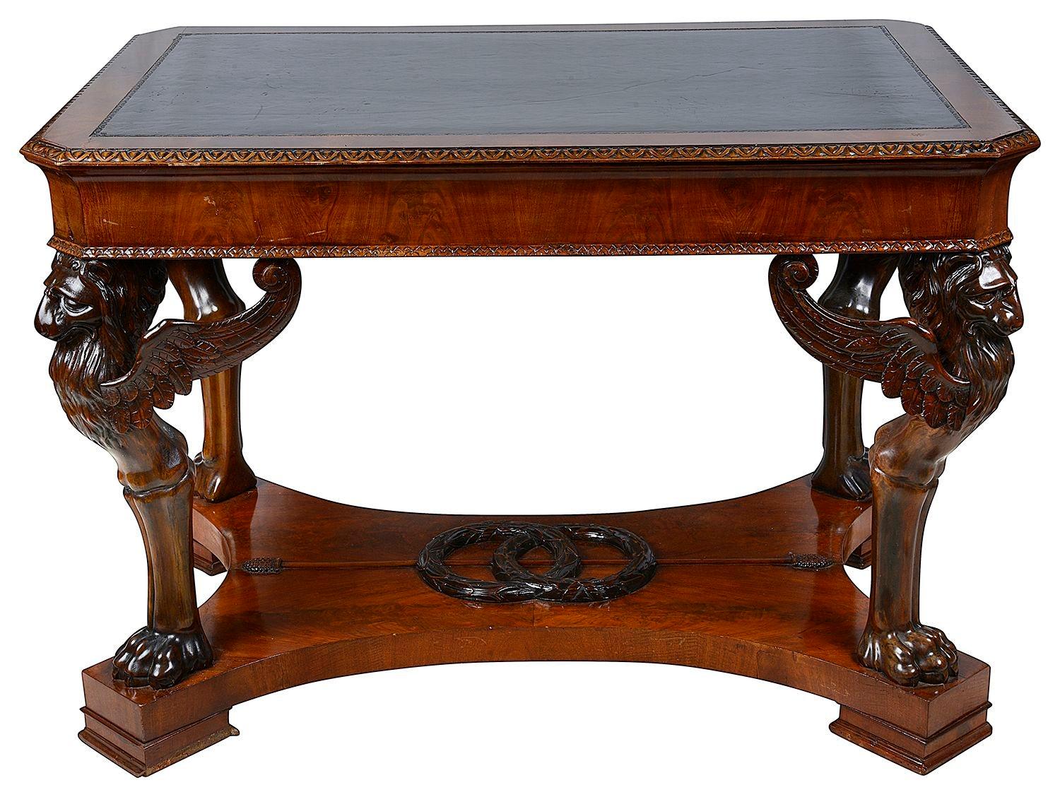A very impressive good quality French Empire style Mahogany, late 19th century Centre / console table. Having wonderful hand carved monopodia winged Lion supports, inset leather top, and raised on a plinth base with a pair classical wreaths and