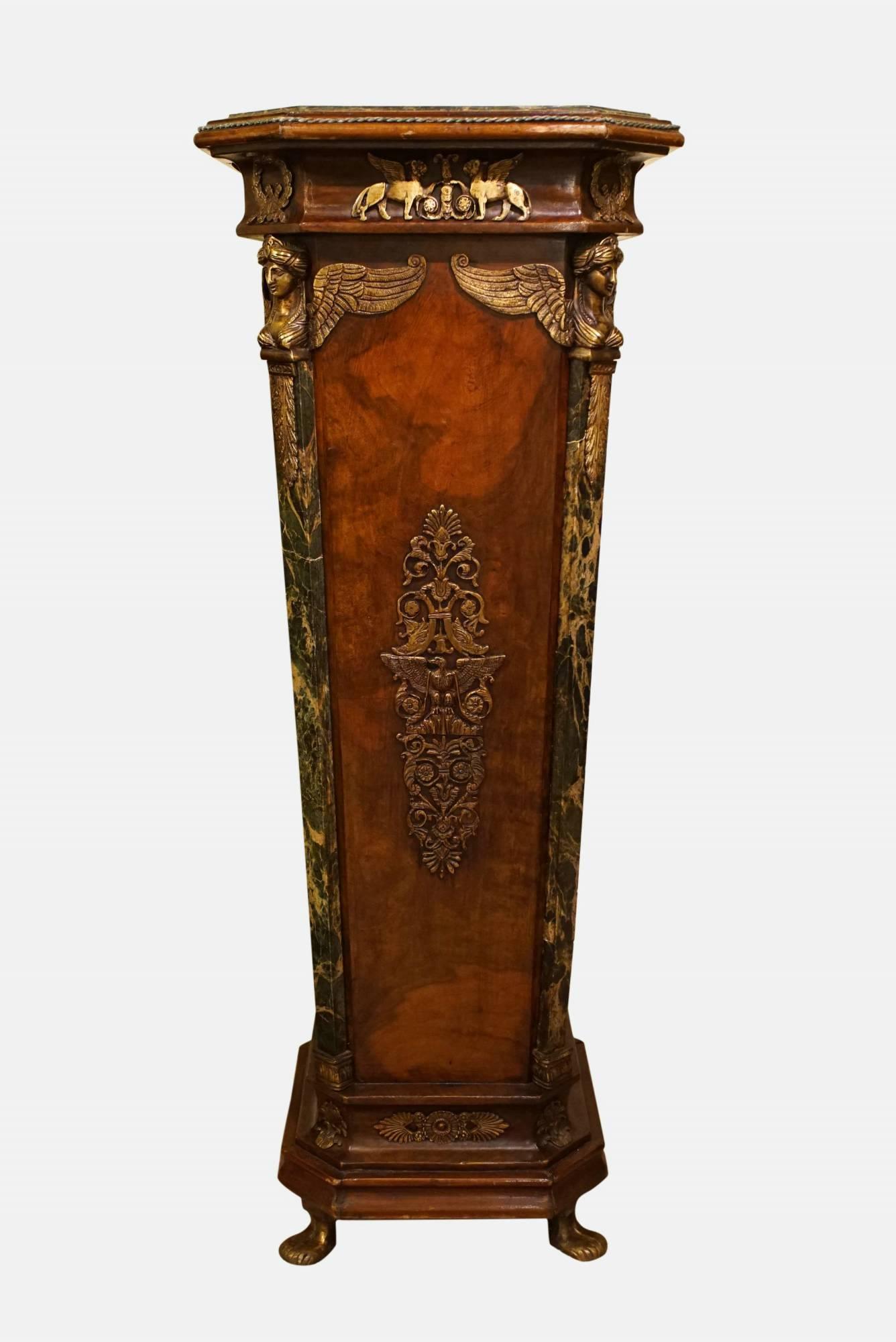 A pair of Empire style marble-topped pedestals with highly decorative ormolu detailing.