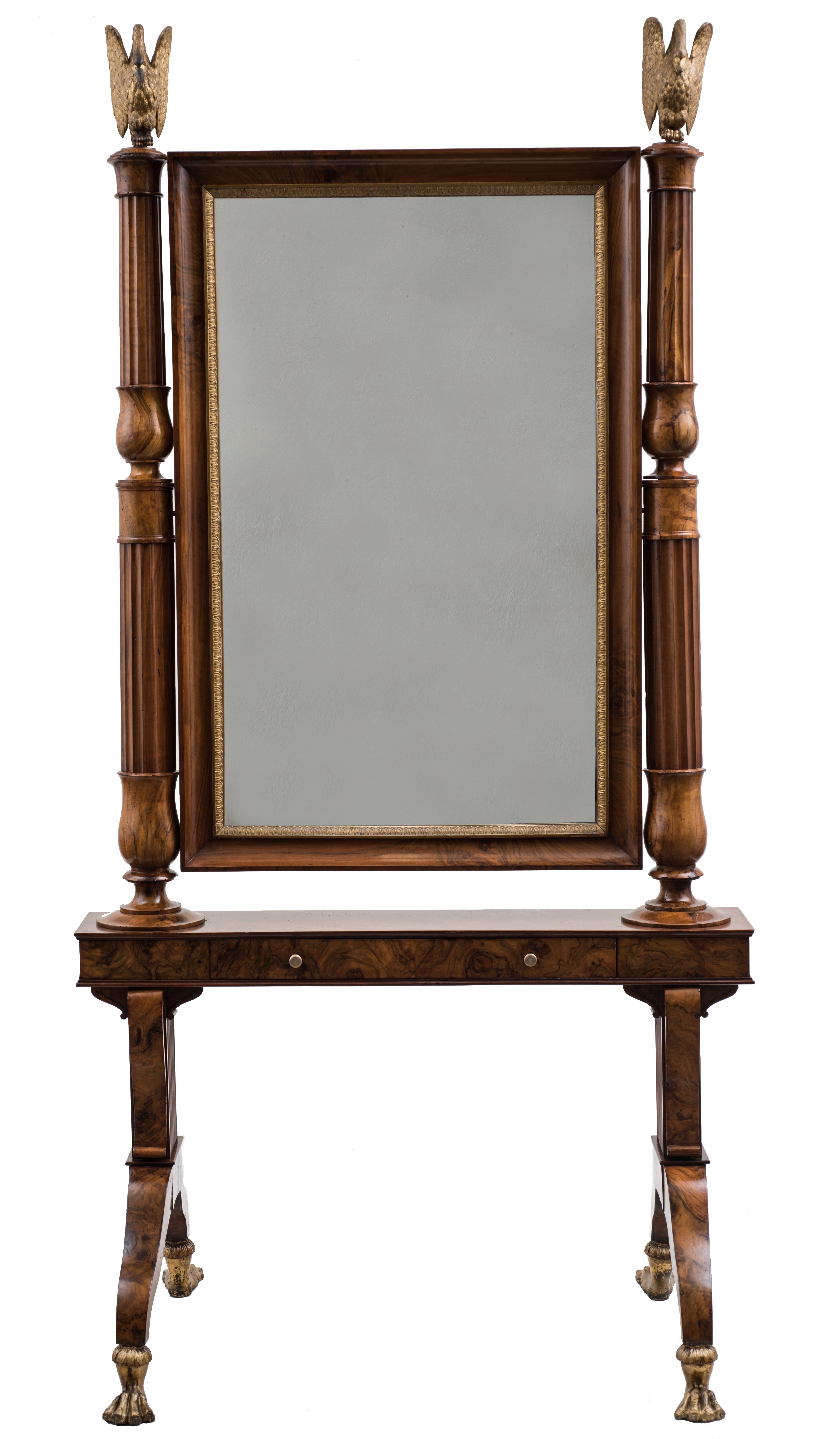 Empire style mirror is a precious decorative object realized in Emilia (Italy) in the first fourth of the 19th century. 

Splendid pivoting mirror (psicè) in walnut and briar of olive. The mirror frame is decorated with Empire leaflets. the mirror