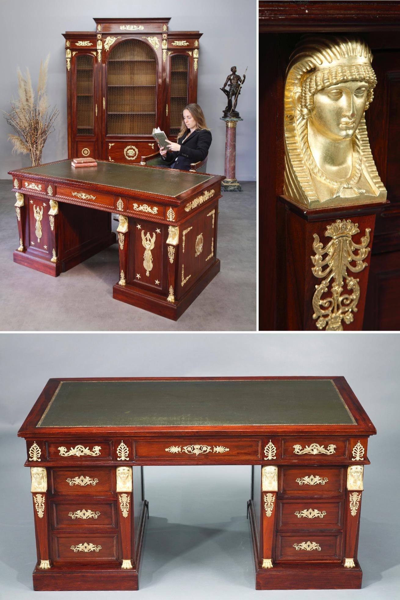 Very large and majestic Empire style desk from 1875, double sided, in mahogany and mahogany veneer. It is composed of two boxes opening with six drawers and a central tray opening with three drawers in front. The desk is beautifully decorated with