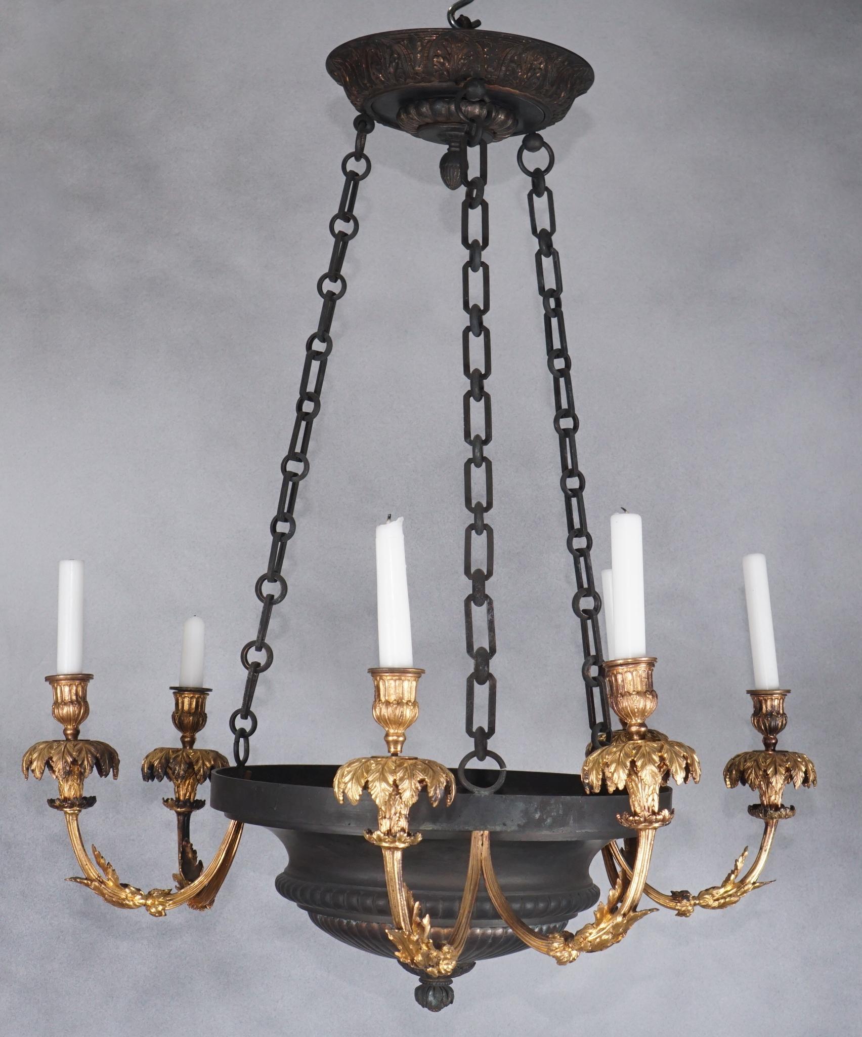 Designed as a shallow gadrooned bowl with six gilded bronze arms currently not wired and used as a candle fixture but can easily be wired for an additional charge if the customer desires. The arms exhibit some features that are similar to designs