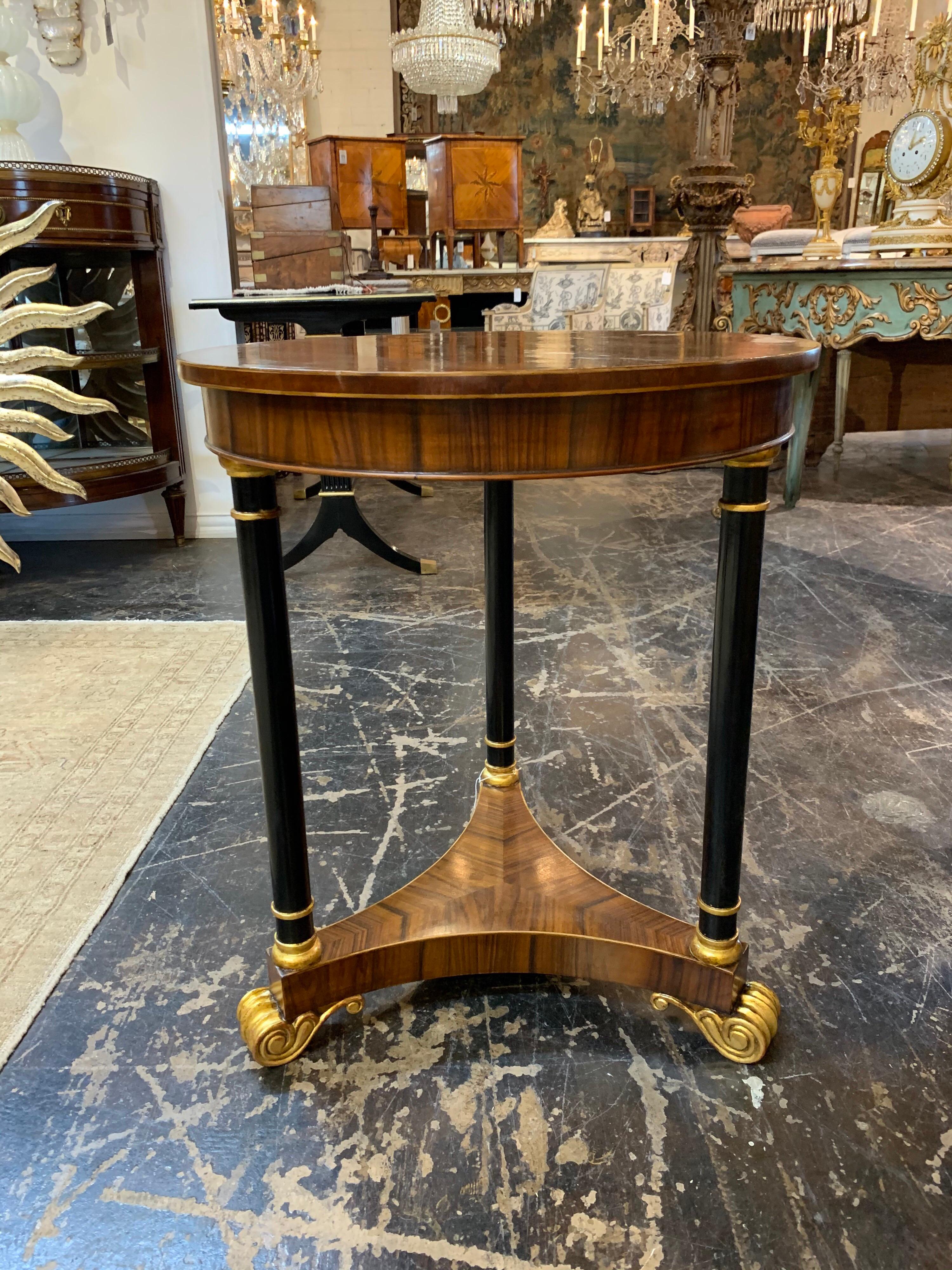 Very handsome Empire style rosewood side table with ebonized detail and gilt trim.
Beautiful finish on this piece. A classic design that is so elegant!