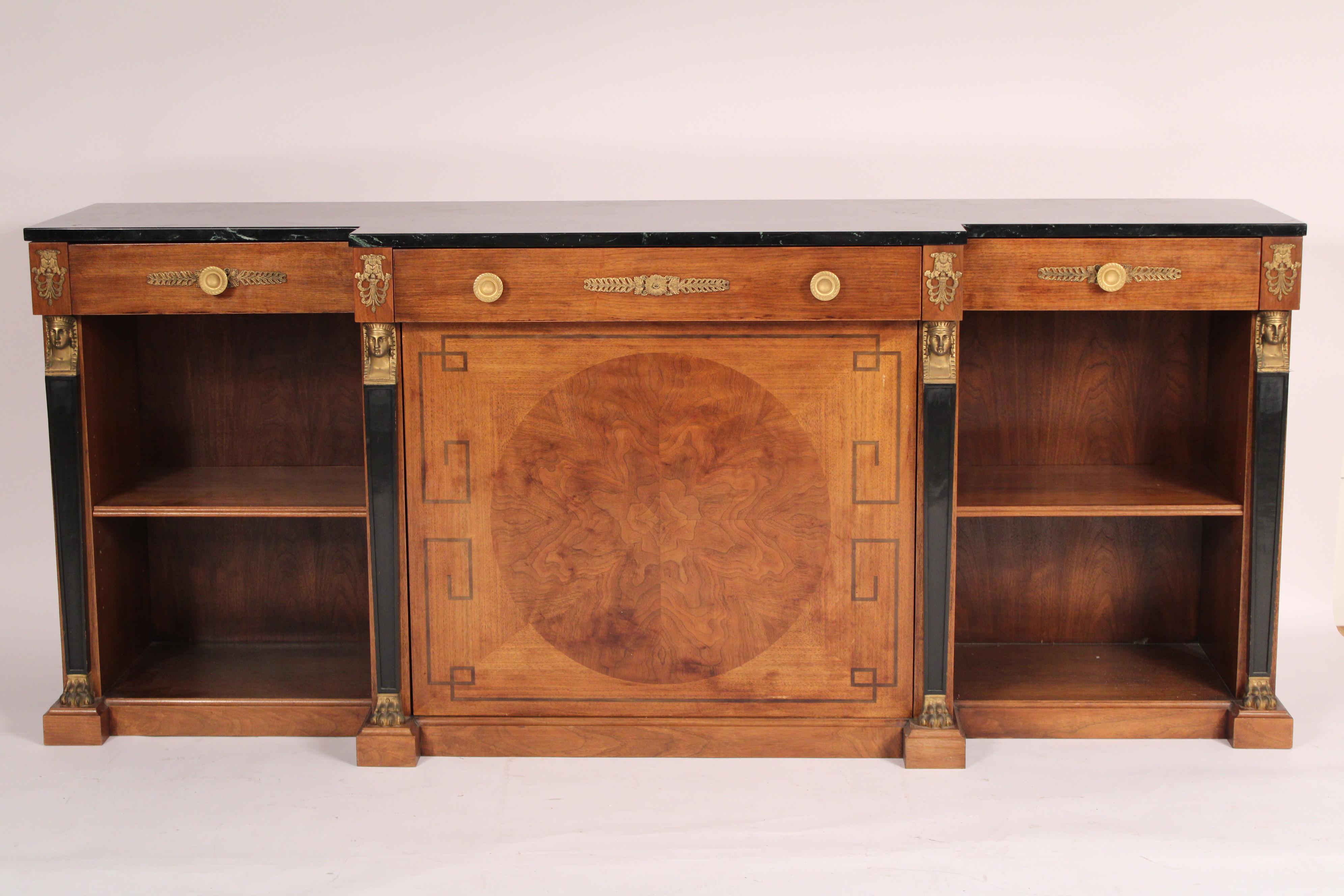 Empire style mahogany sideboard / bookcase with marble top and gilt bronze mounts, circa 1970s. With marble top, three frieze drawers, two bookcases on either side of a central door with large circular burl panel, 4 black lacquer columns with gilt