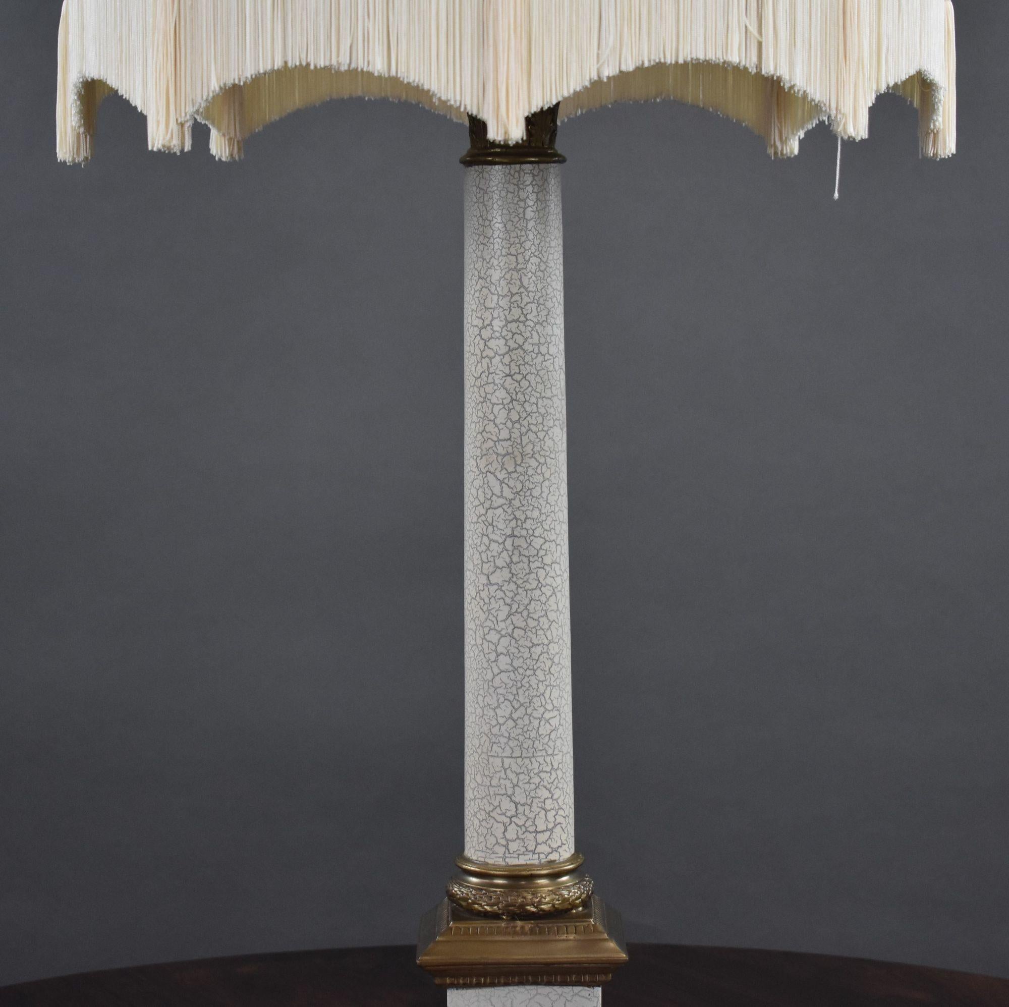Empire style lamp with standing height with shade 97cm in good condition. The lamp has a crazed white stem with brass accents. The lampshade is a tan suede colour with white tassles.