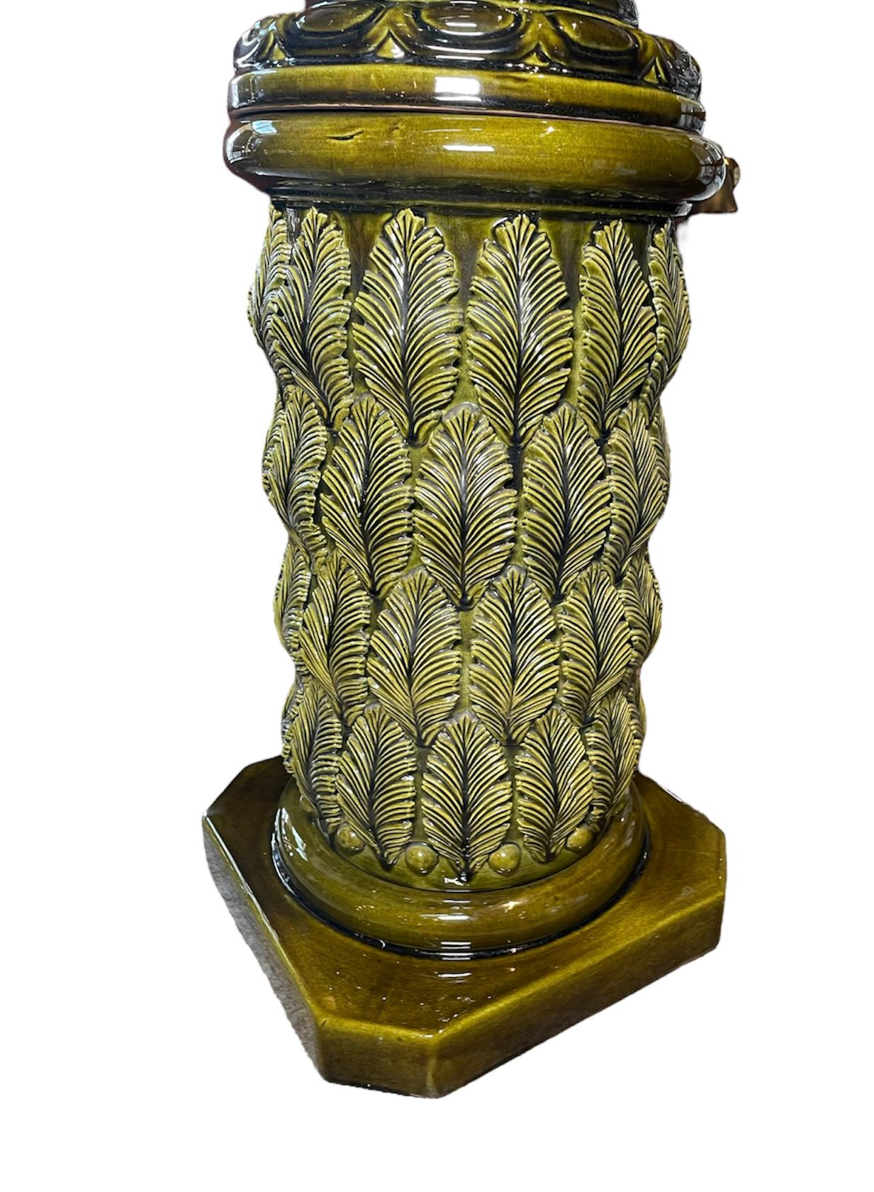 This is an olive green color set of large Spaniard Cerámicas Bondia Jardiniere and pedestal. The Jardiniere is decorated with a relief of Empire style swans with open feathers around a bell shaped upside down vase. The pedestal is cylindrical shaped