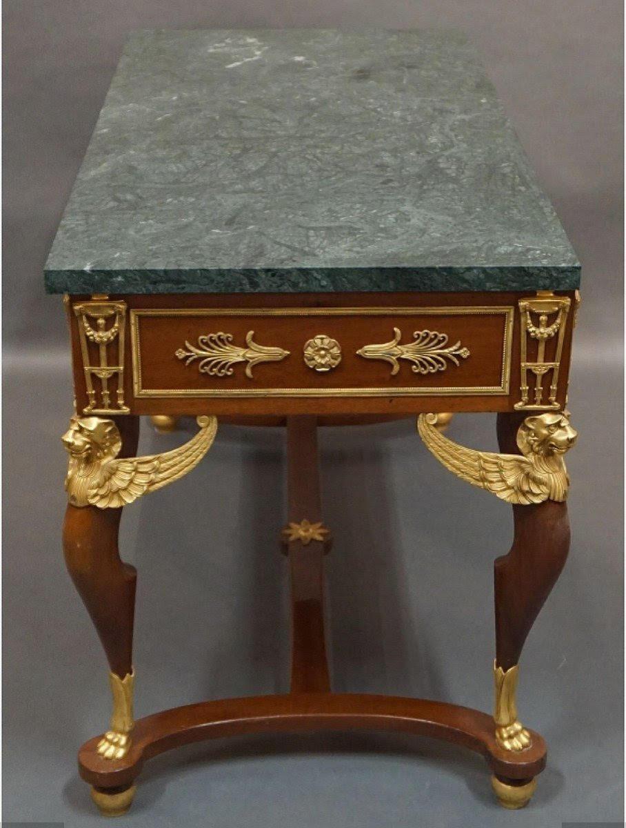 Empire style table, desk in gilt bronze, mahogany and marble.

19th century or early 20th century Empire style mahogany and gilt bronze table, desk, green marble top, 2 drawers.  
H: 76.5cm, W: 118cm, D: 59cm
