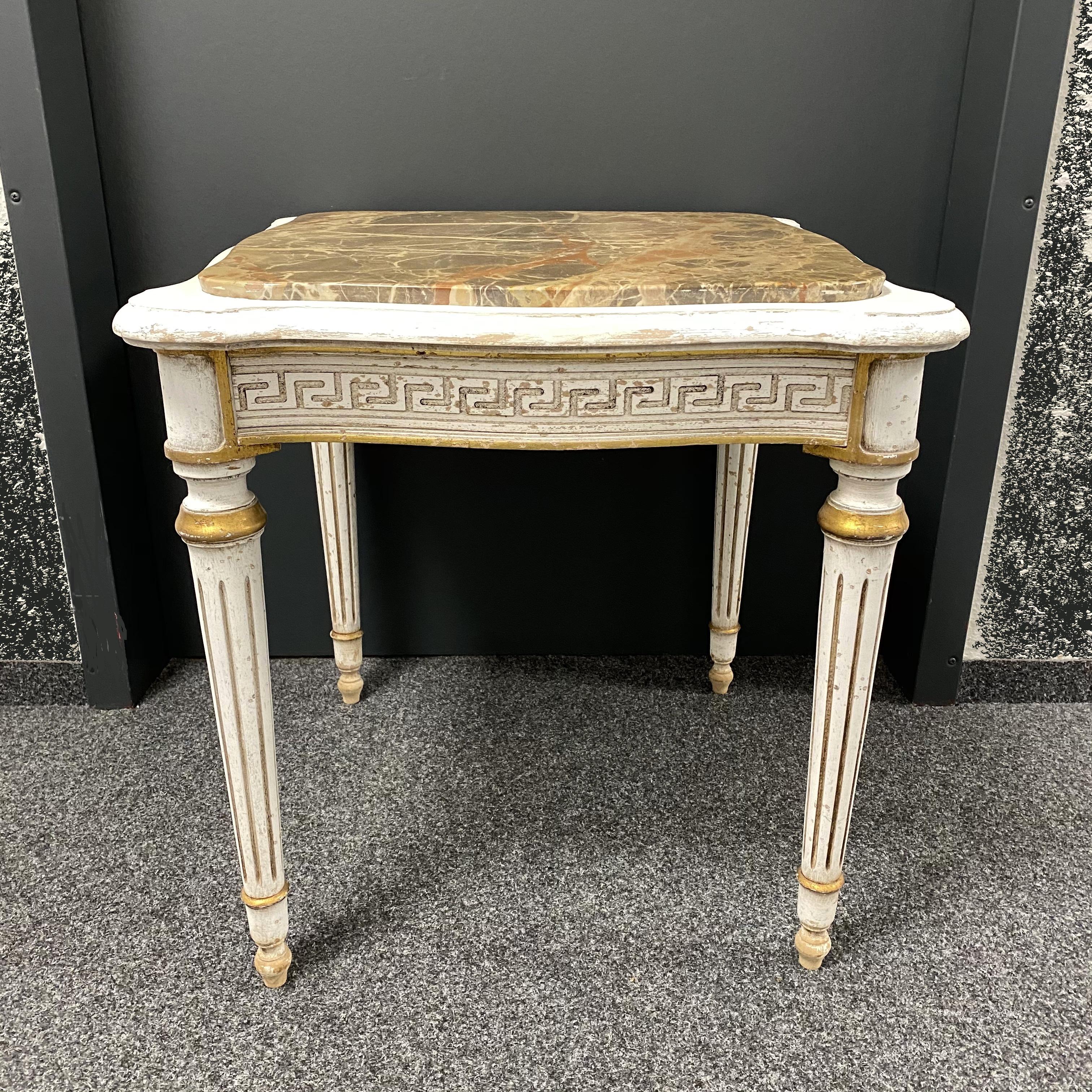 A gorgeous chippy white paint table in an Empire style. This table has beautiful guilt details throughout. Add an elegant touch to your home with this exceptional vintage highly decorative furniture. Again, the table is in original as found