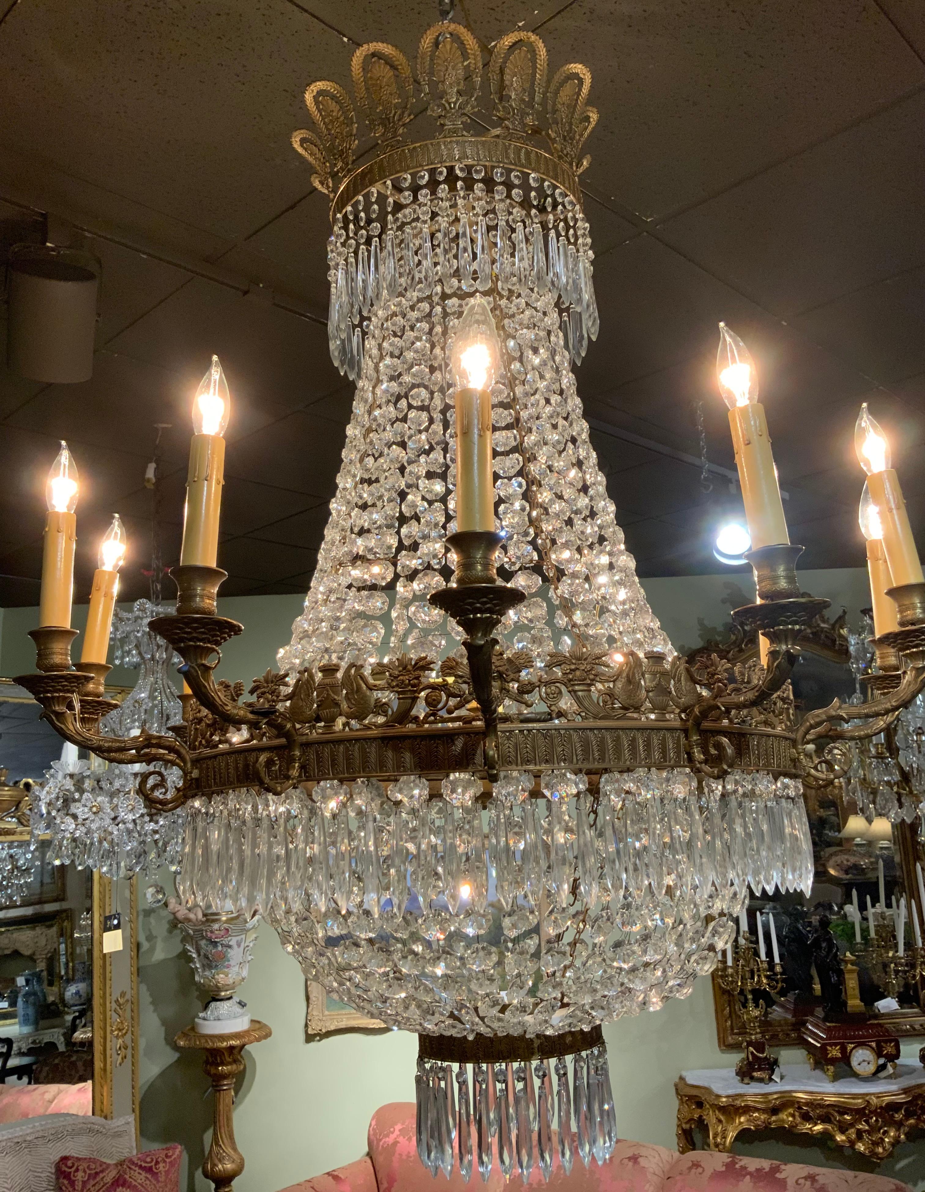 Fine antique clear crystal chandelier having 12 lights.
It is in the empire style with the lights surrounding the
Outer rim of the fixture. The wiring is good and the crystal is
Complete, original and has been cleaned. The bronze work
Is finely cast