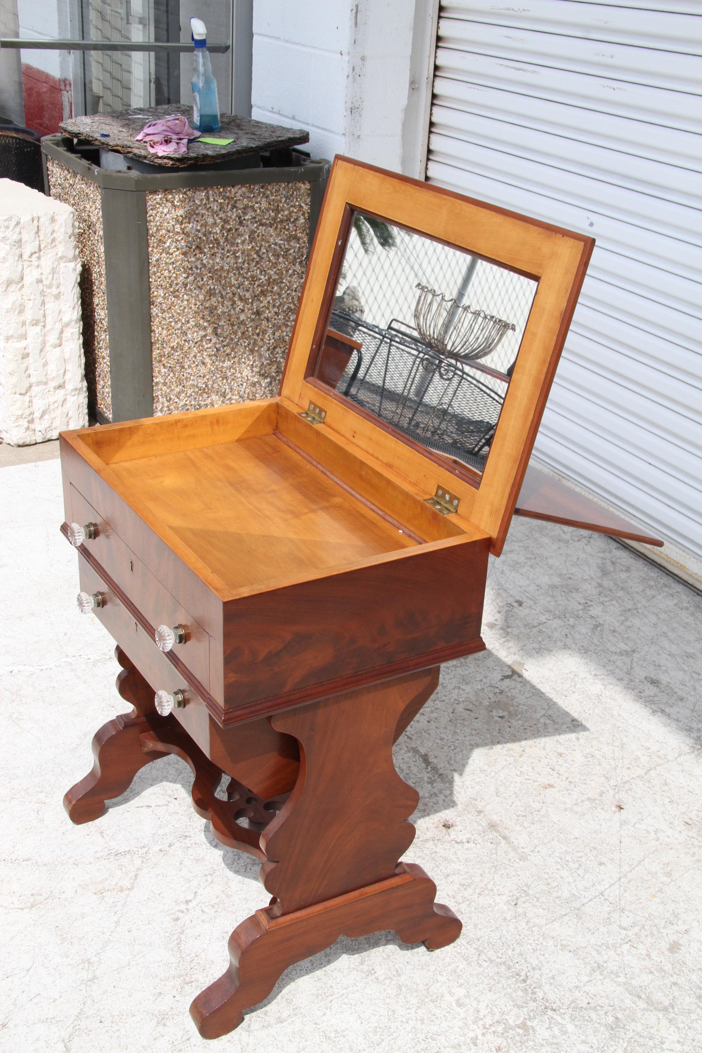 Empire Style Walnut Dressing Table

Empire style dressing table in burl walnut with 2 drawers. Venetian glass pulls. The flap reveals a large original mirror and a jewelry drawer underneath. 

H: 31.50 x W: 27.00 x D: 19.00