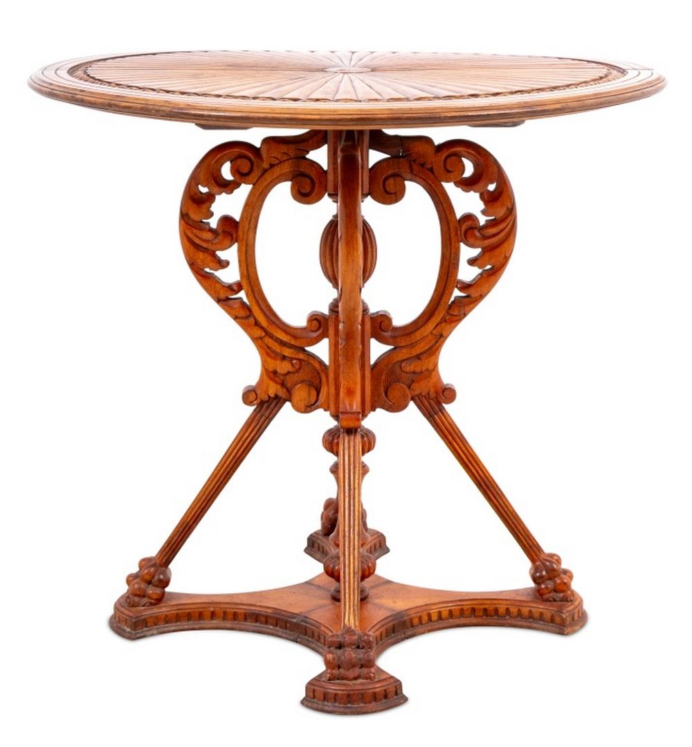 Empire Style Walnut Lamp Table, 20th century, the circular carved top above a quatre partite base, with paw feet on a conforming plinth. 23.5