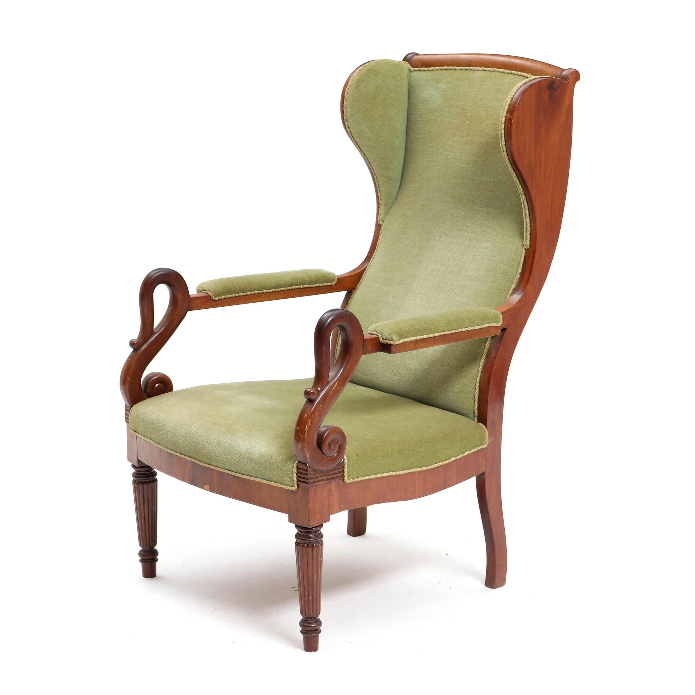 A fine, elegant, 19th century Late Empire mahogany wing-back armchair, armrests shaped as swan heads.