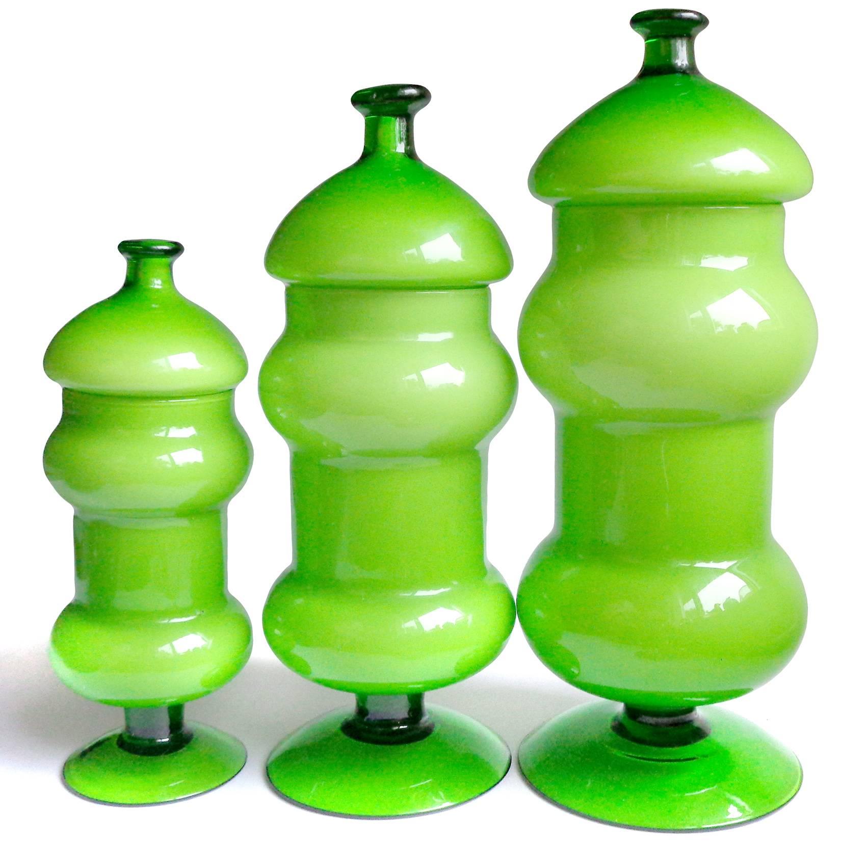 Beautiful vintage set of three hand blown, bright kelly green over white Italian art glass containers / jars. Attributed to the Empoli company, circa 1960-1970s. They go from small to large sizes. Can be used as a display pieces on any table,