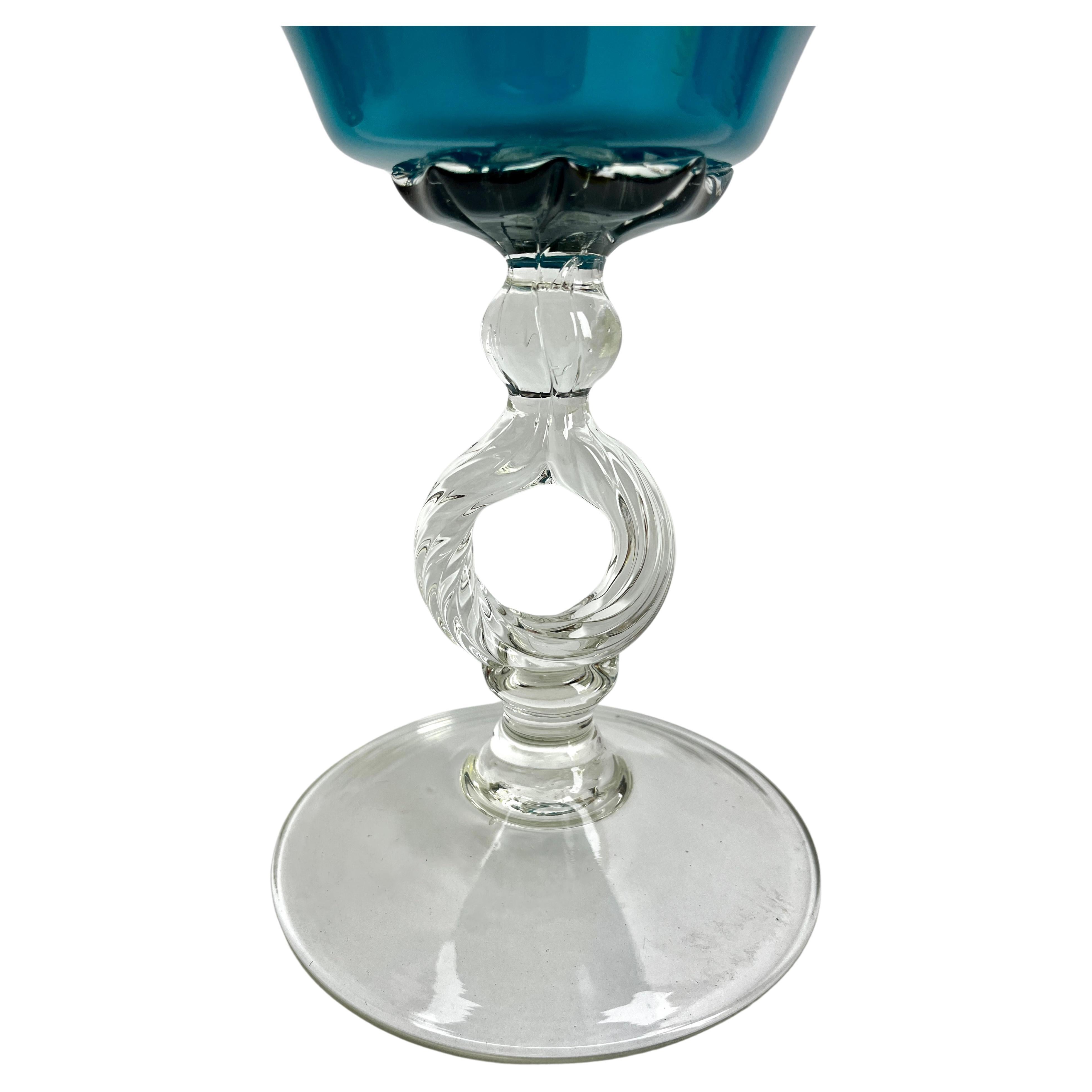 Empoli 'Florence, Italy' Bonbonière on foot in opaline glass, 1960s

Typical decors from the glass factories of Florence, Italy, collectively known as Empoli.
With best wishes, Geert.

Decorative blue glass. The city of Empoli is located in the