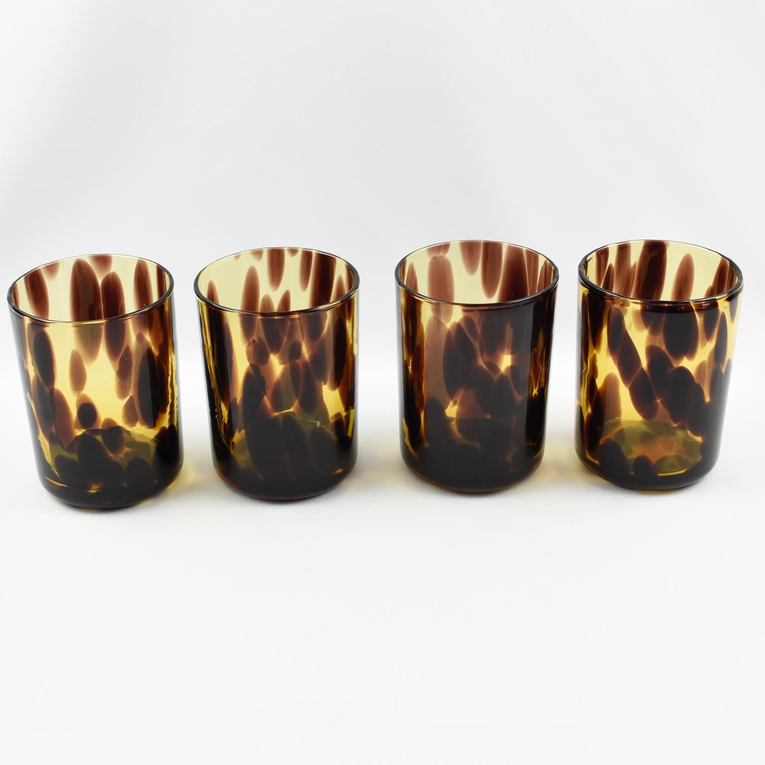Elegant barware, bar set manufactured by Empoli, Italy for Christian Dior Home Collection. Set of four tumbler glasses. Mouth-blown with exclusive tortoiseshell color flowing pattern. 
Measurements: 3.38 in. diameter (8.5 cm) x 4.50 in. high (11.5