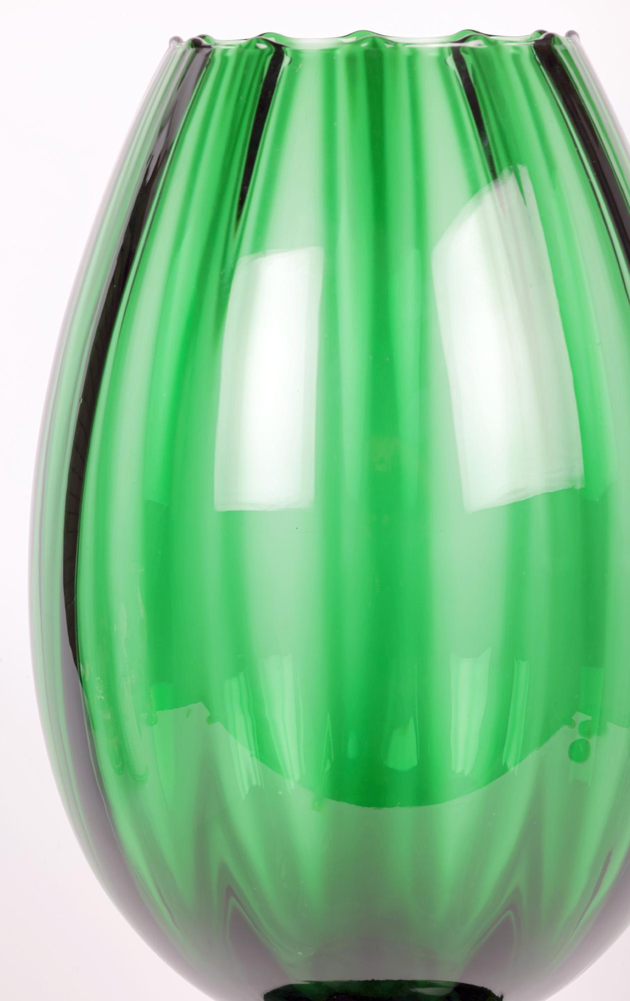 A large and impressive mid-century hand-blown Italian art glass green pedestal goblet shaped vase by renowned glass makers Empoli and dating from around 1960/70. The vase has a tall bud shaped body with vertical grooved patterning forming small