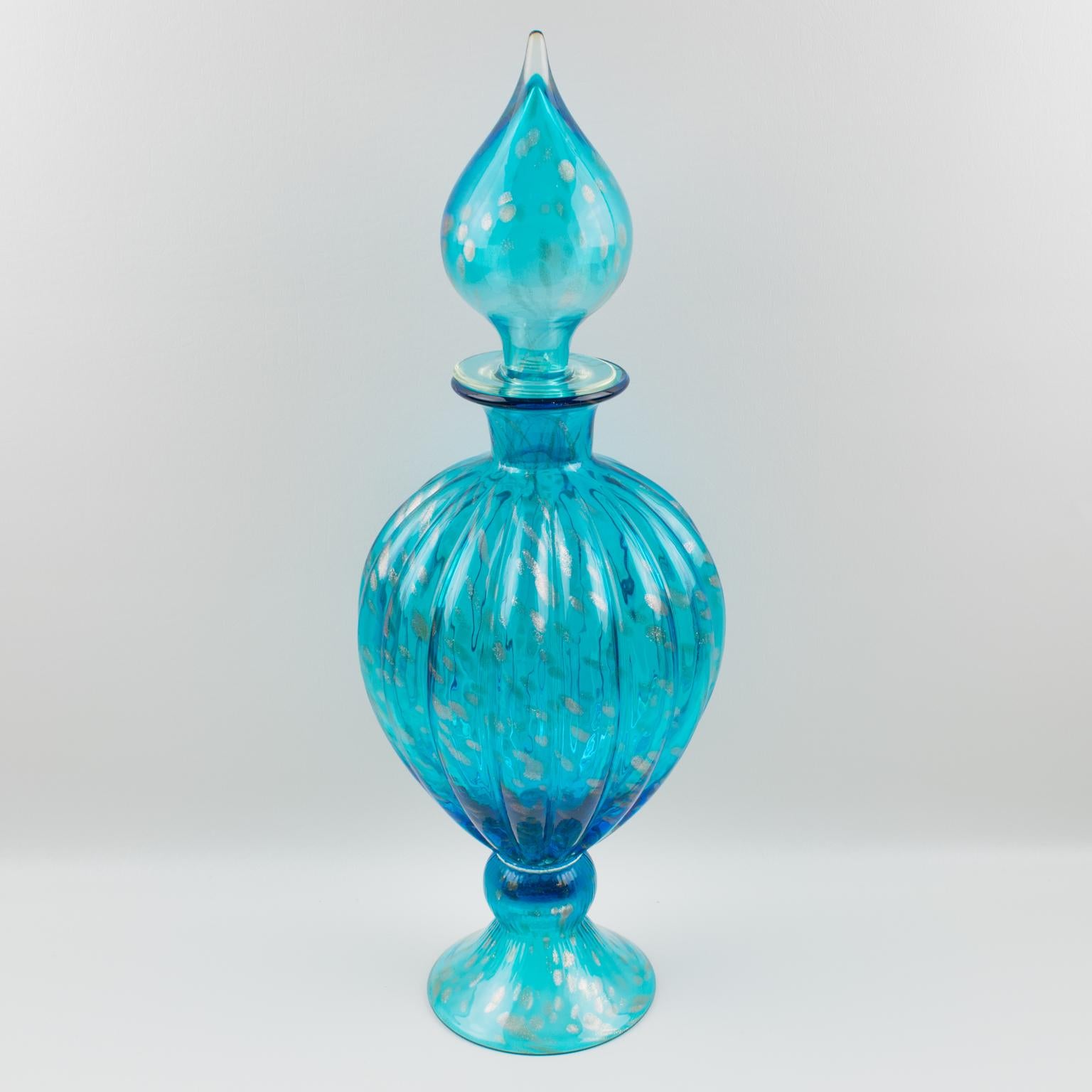 Nice oversized turquoise blue glass apothecary dispenser or jar, made in Italy in the region of Empoli. A stately and eye-catching piece that can stand alone, with beautiful patterns and elegant transparent turquoise blue color with gold flake