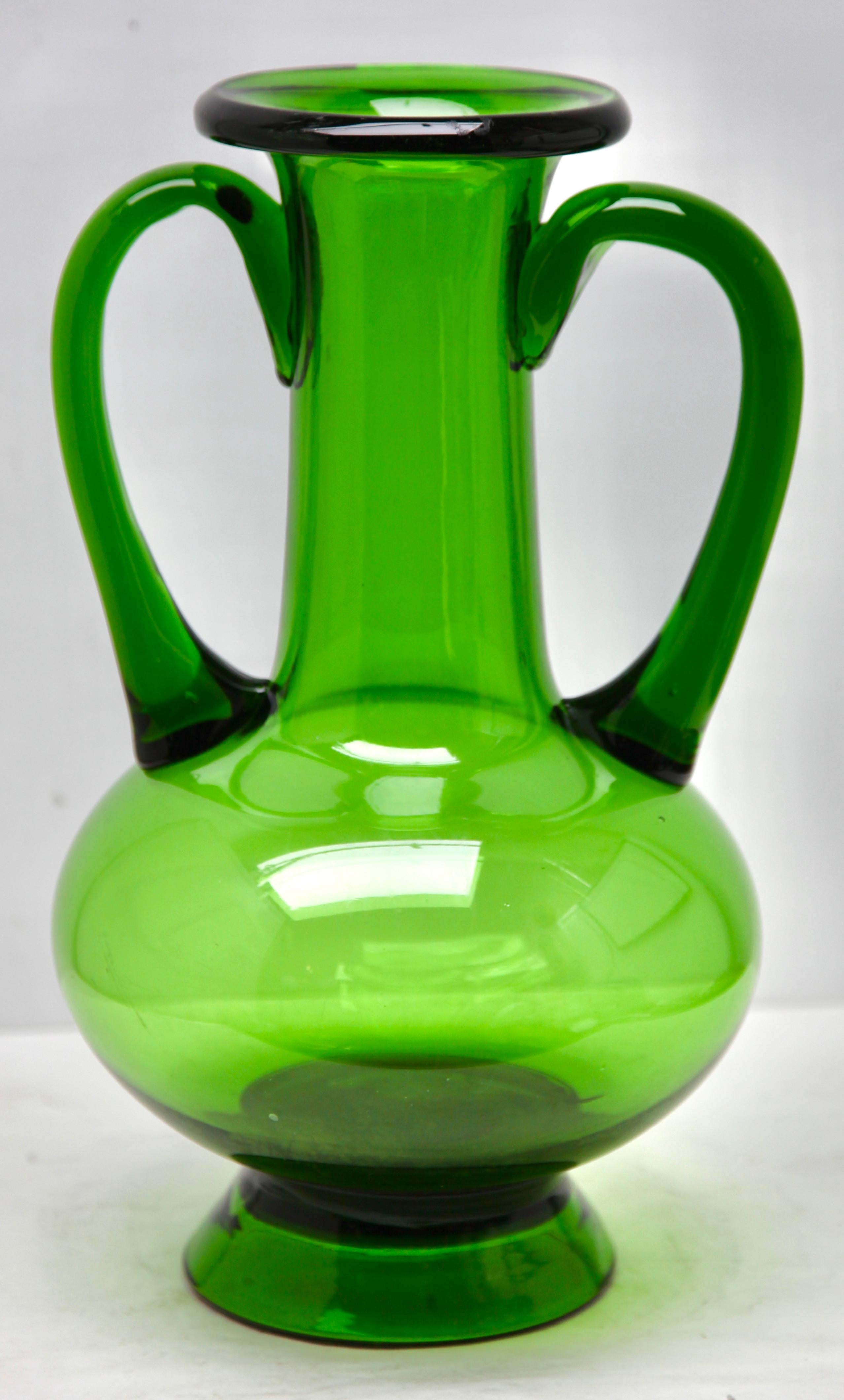 Made by the Italian craftsmen of Empoli, Florence

The carefully crafted details add flowing organic motifs and act as a handle to ensure they can be safely carried.
The large, usable vase provides a solid pitcher form suitable for a few tall