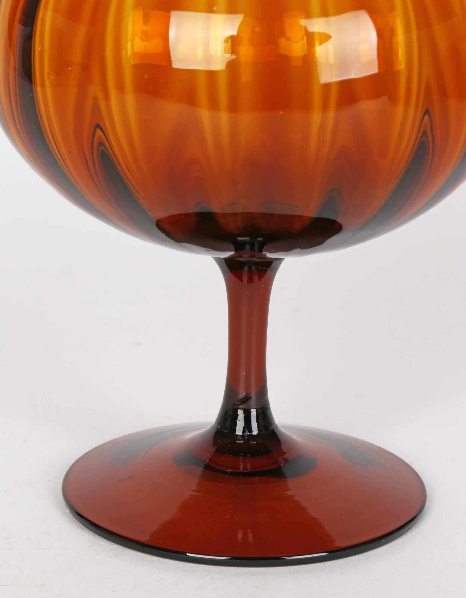 A stunning Italian mid-century hand-blown amber glass pedestal bowl by Empoli. This very stylish piece is beautifully made and stands on a slightly domed wide rounded foot with a narrow pedestal stem supporting a round bowl shaped top with a ribbed