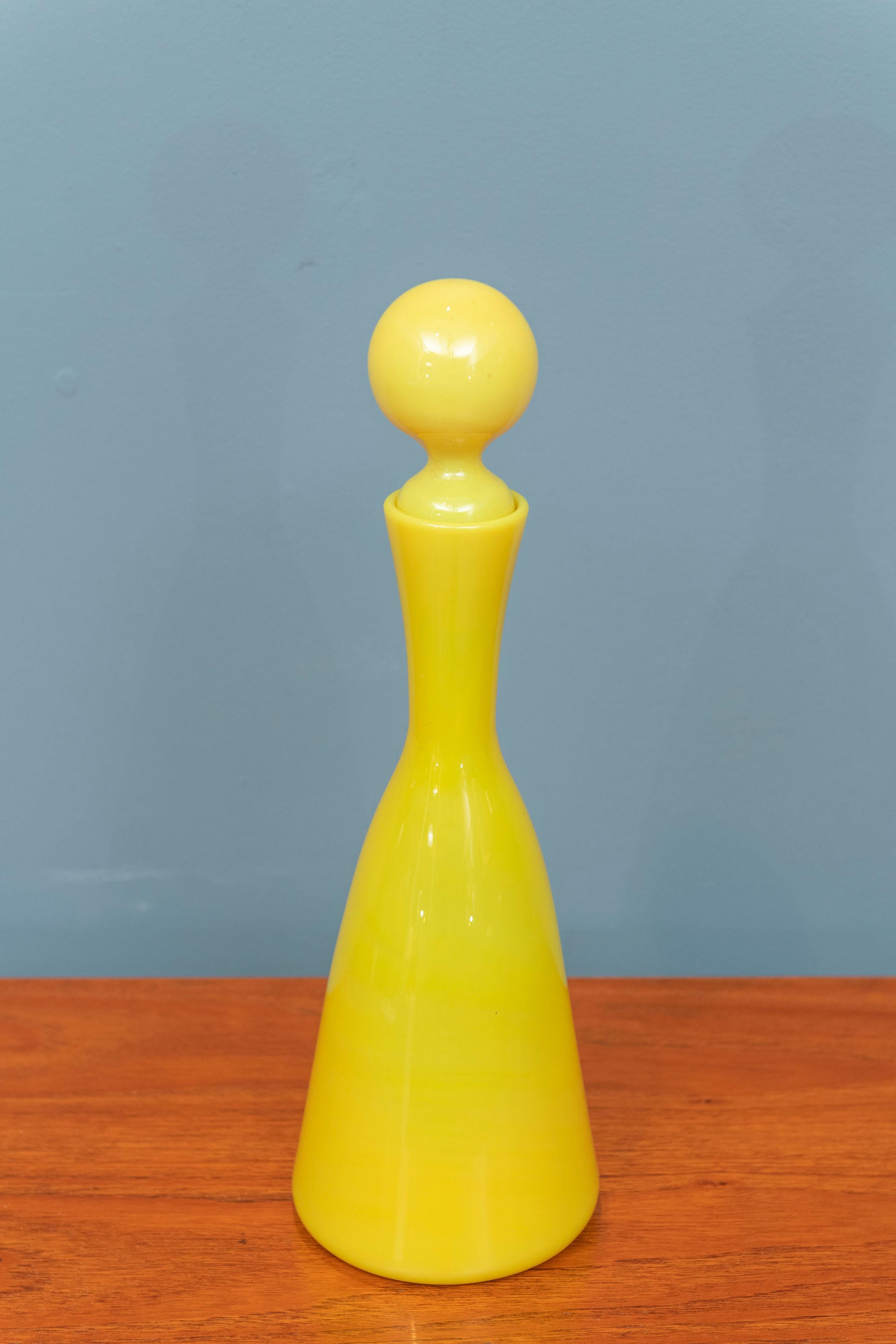 Empoli yellow glass decanter, Italy. Gorgeous and vibrant transparent lemon yellow blown glass decanter or bottle with matching stopper. Rare color and form for decoration or liquor.